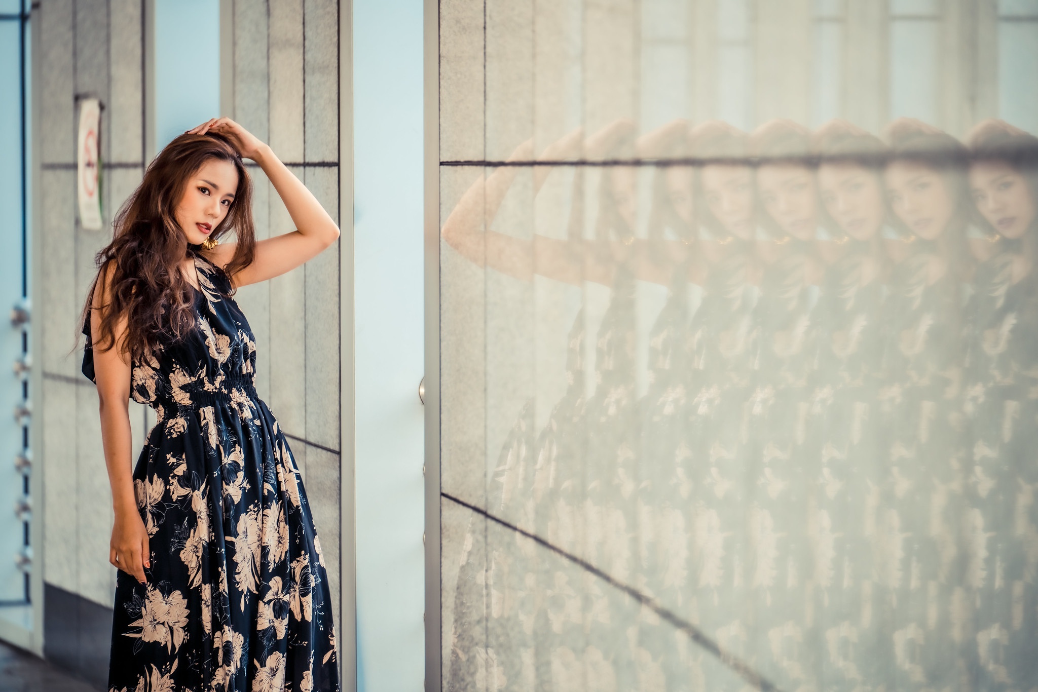 Woman in a floral dress posing near a reflective wall HD Wallpaper