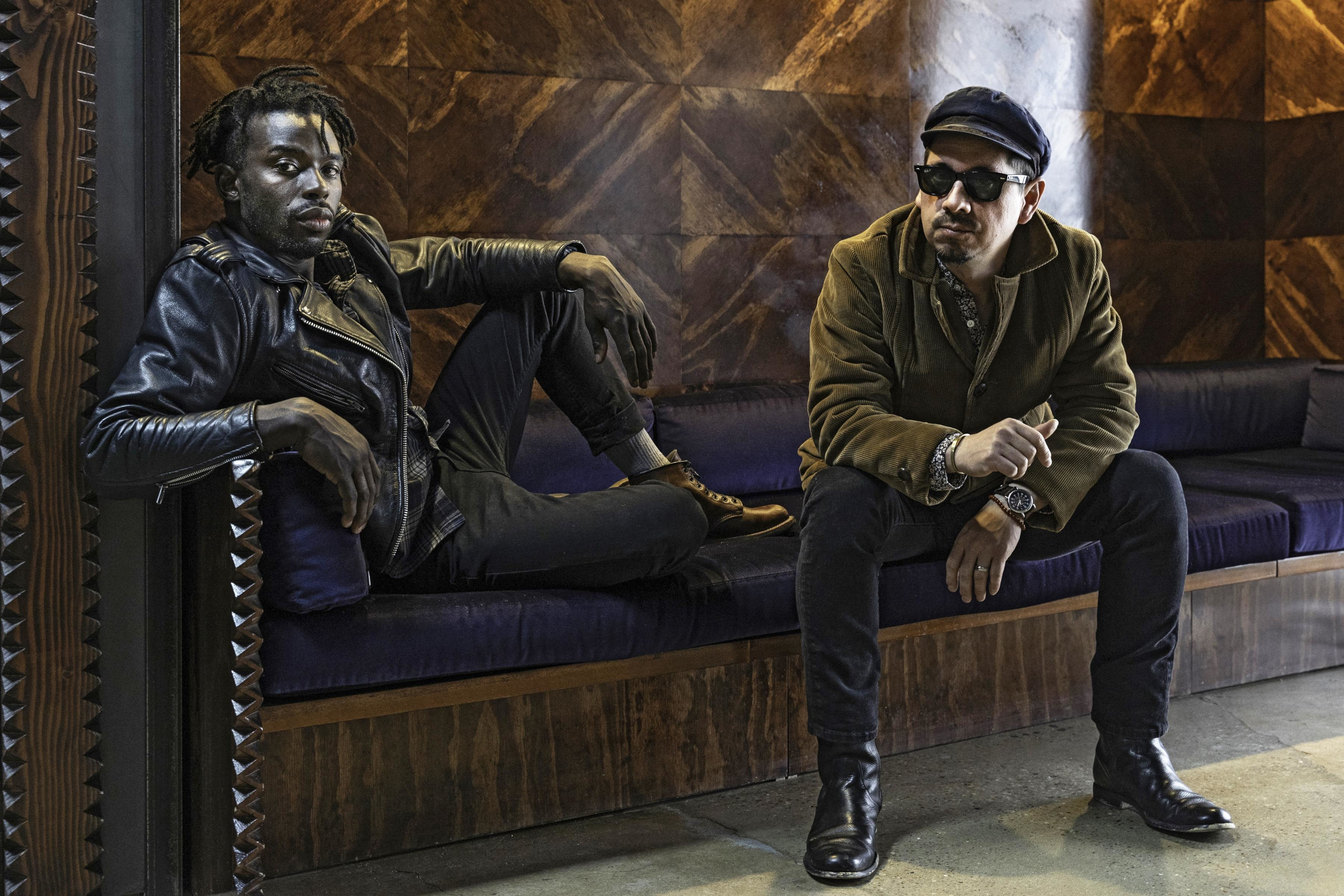 Black Pumas duo sitting on a couch HD Wallpaper