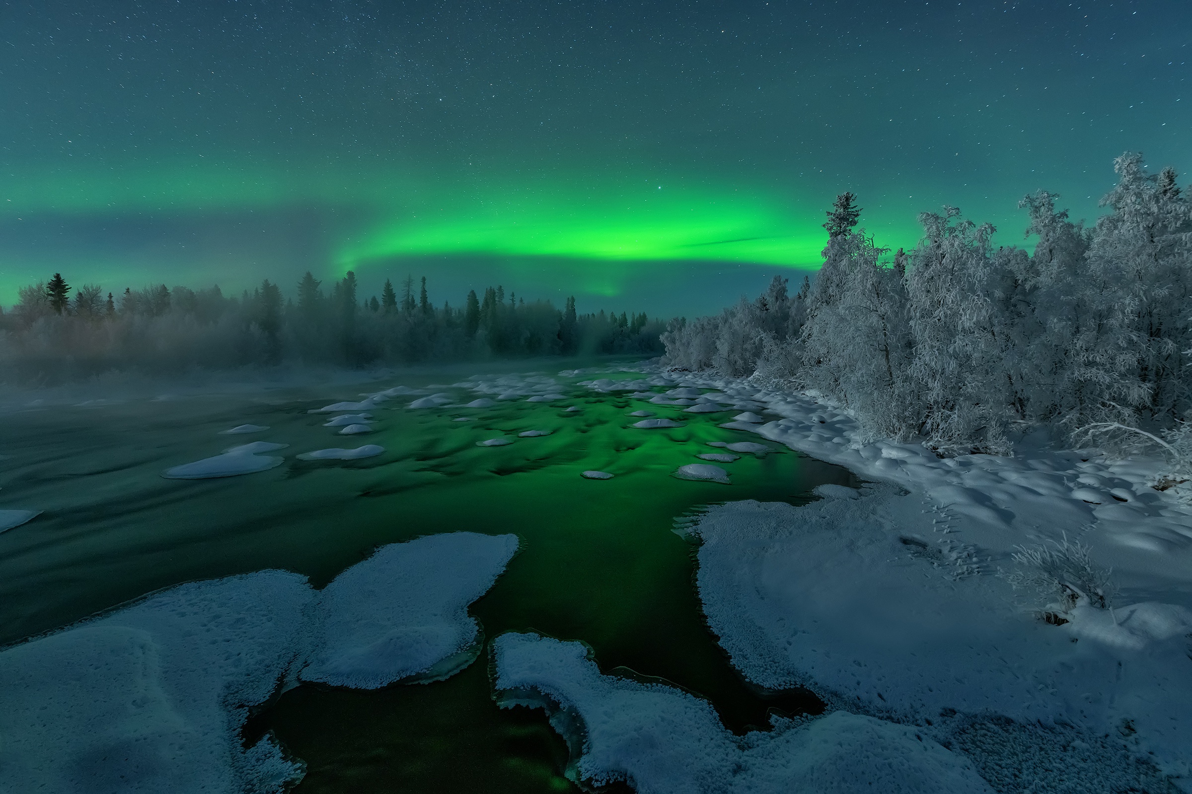 Aurora Borealis over a snowy river at night HD Wallpaper