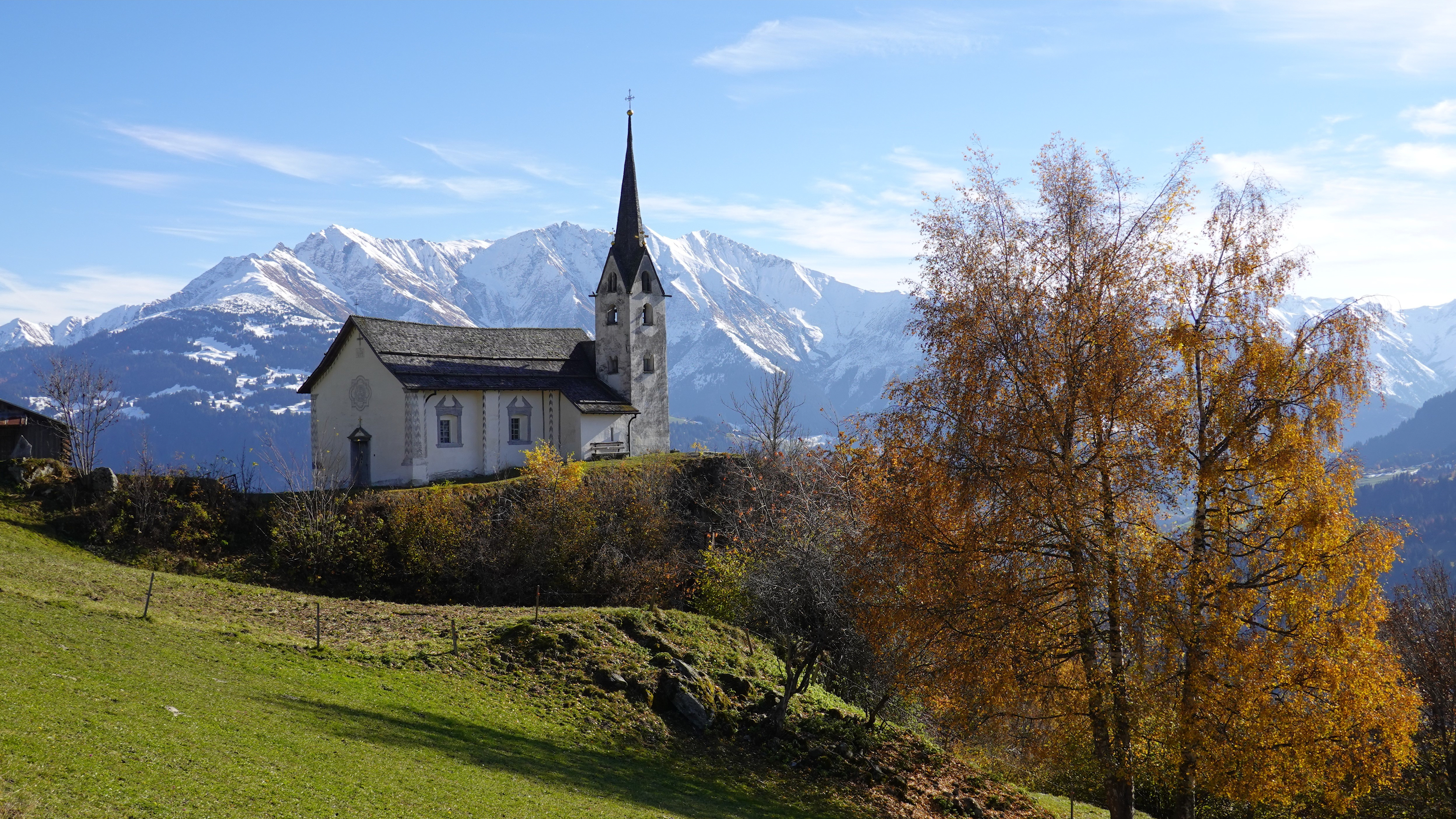 Church on a hill with snow-capped mountains HD Wallpaper
