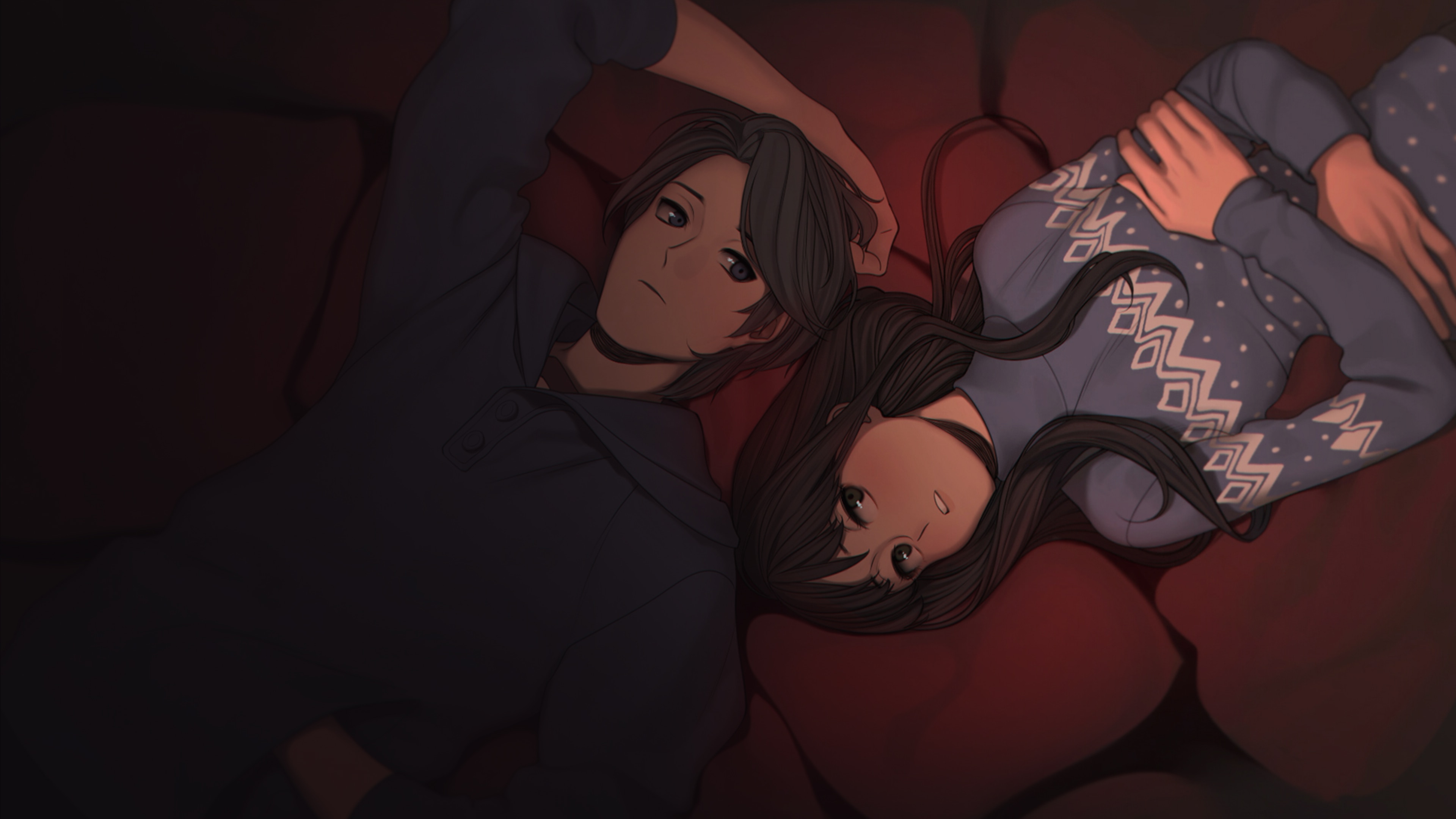 Couple lying down on red cushions HD Wallpaper