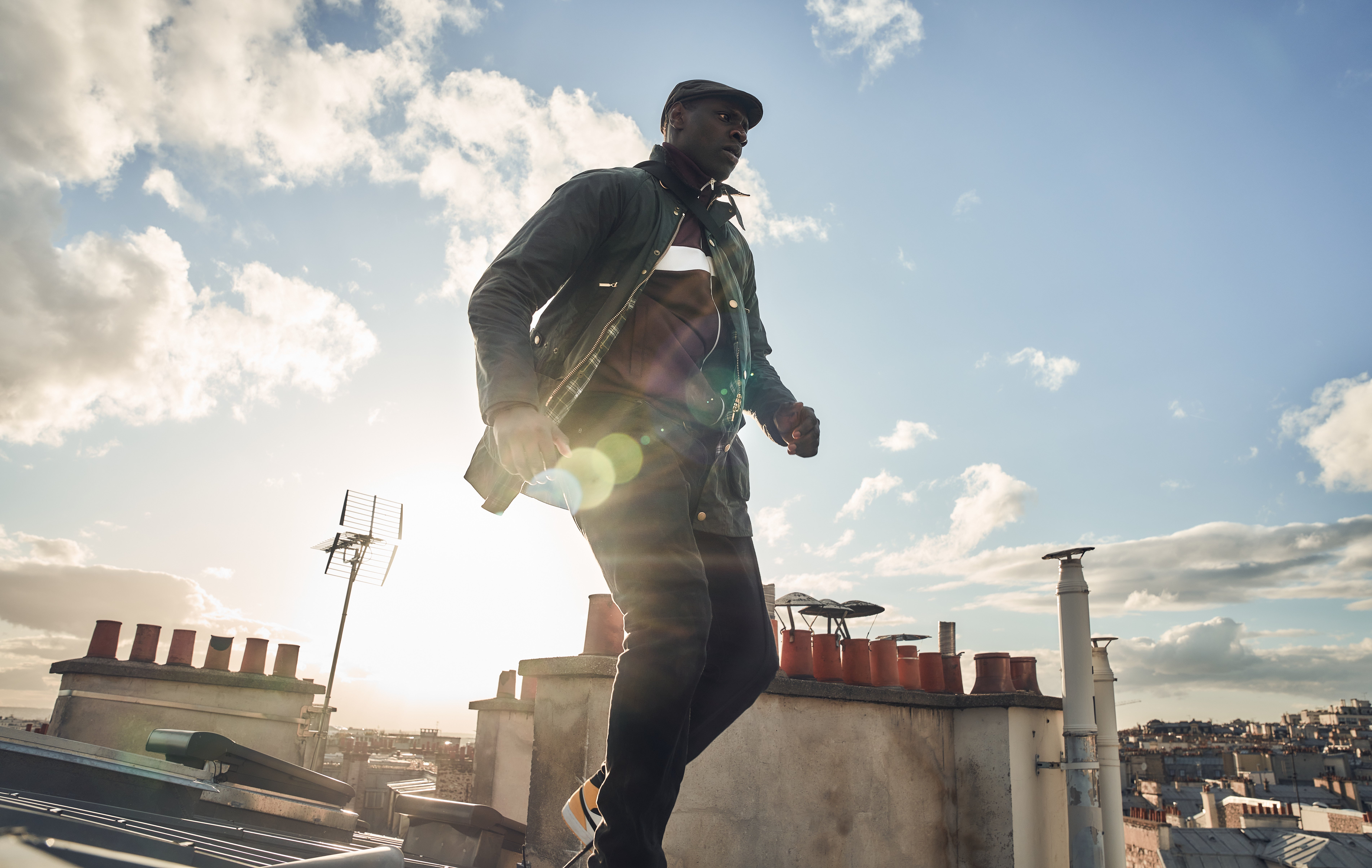 Omar Sy as Lupin on a rooftop HD Wallpaper