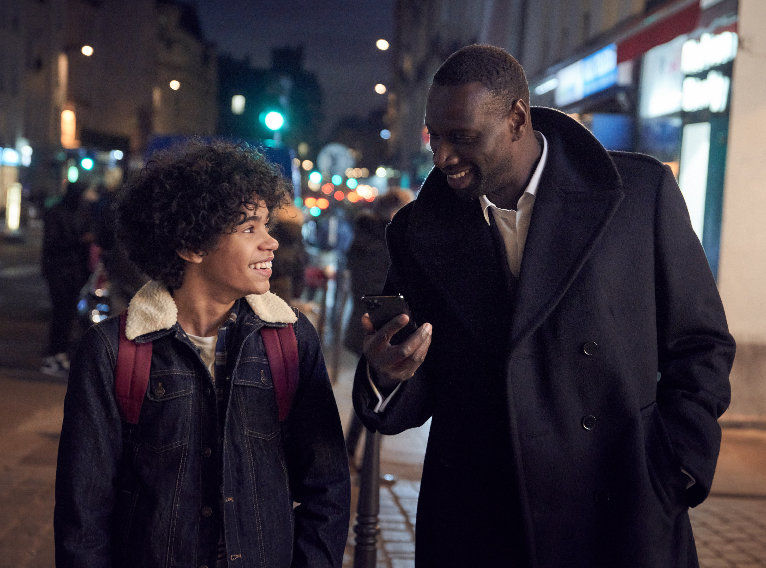 Assane Diop and son from Lupin on a street HD Wallpaper