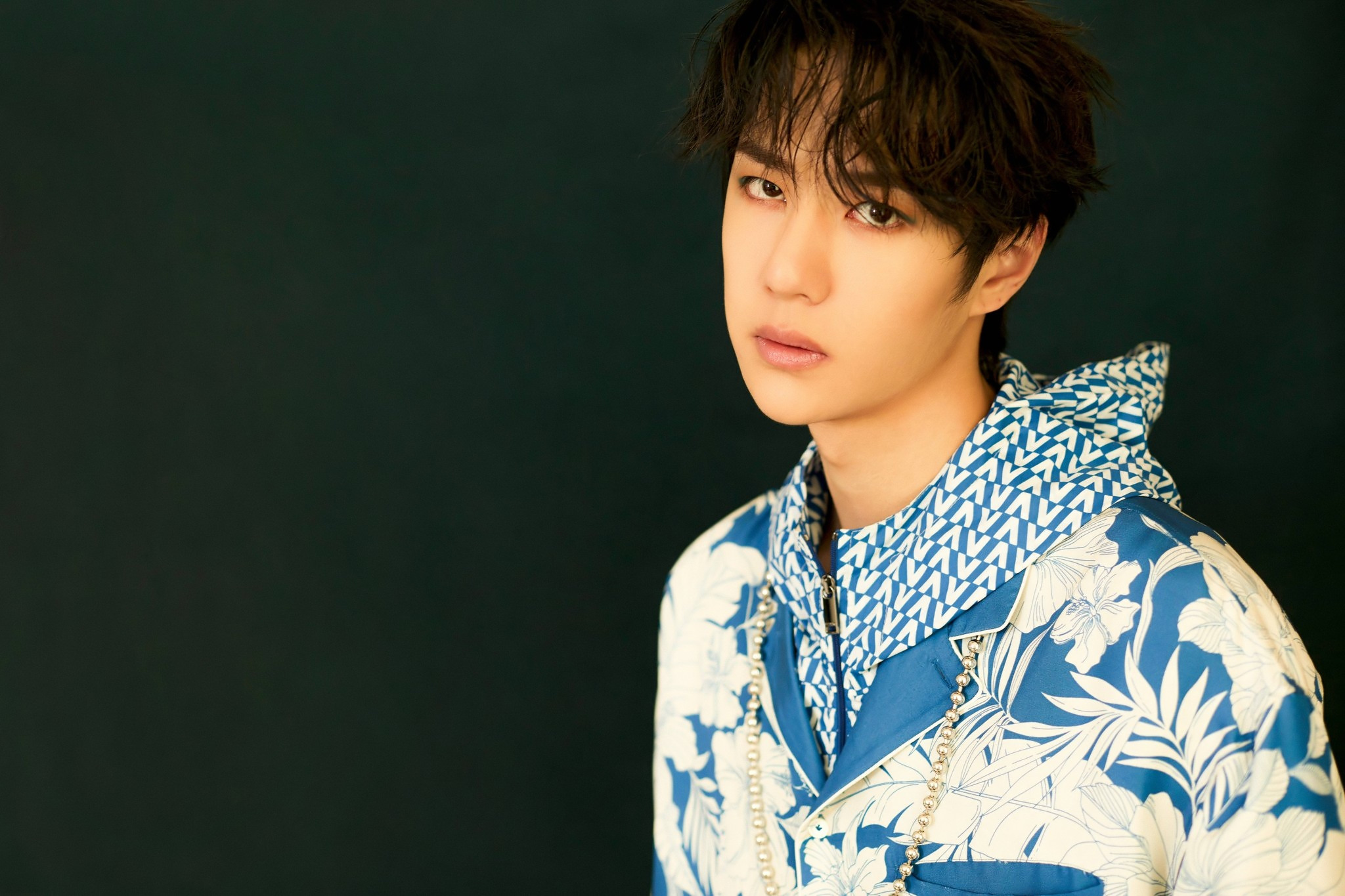 Wang Yibo posing against a dark background HD Wallpaper