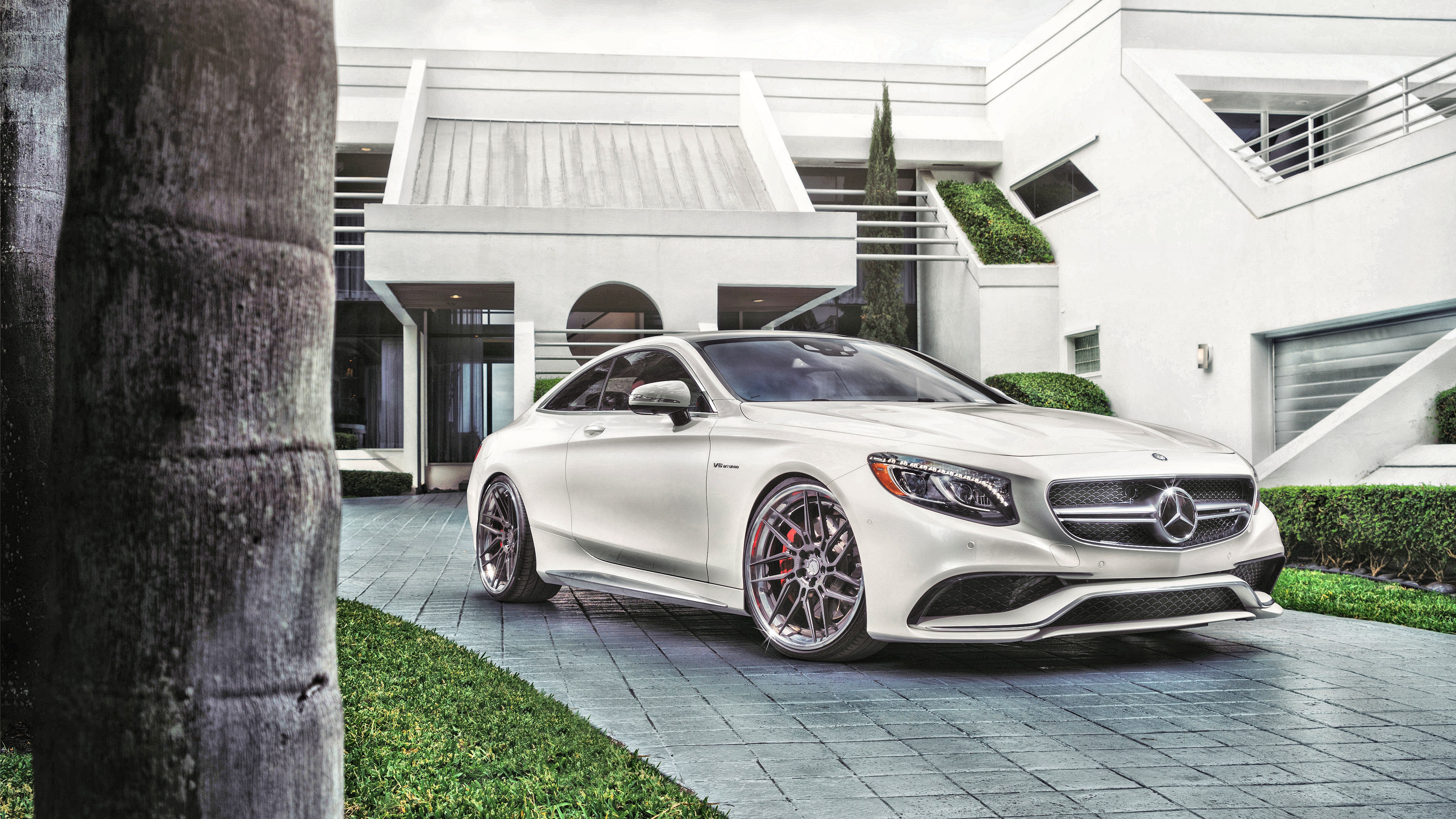 White Mercedes-Benz S63 AMG Coupe in front of modern house HD Wallpaper