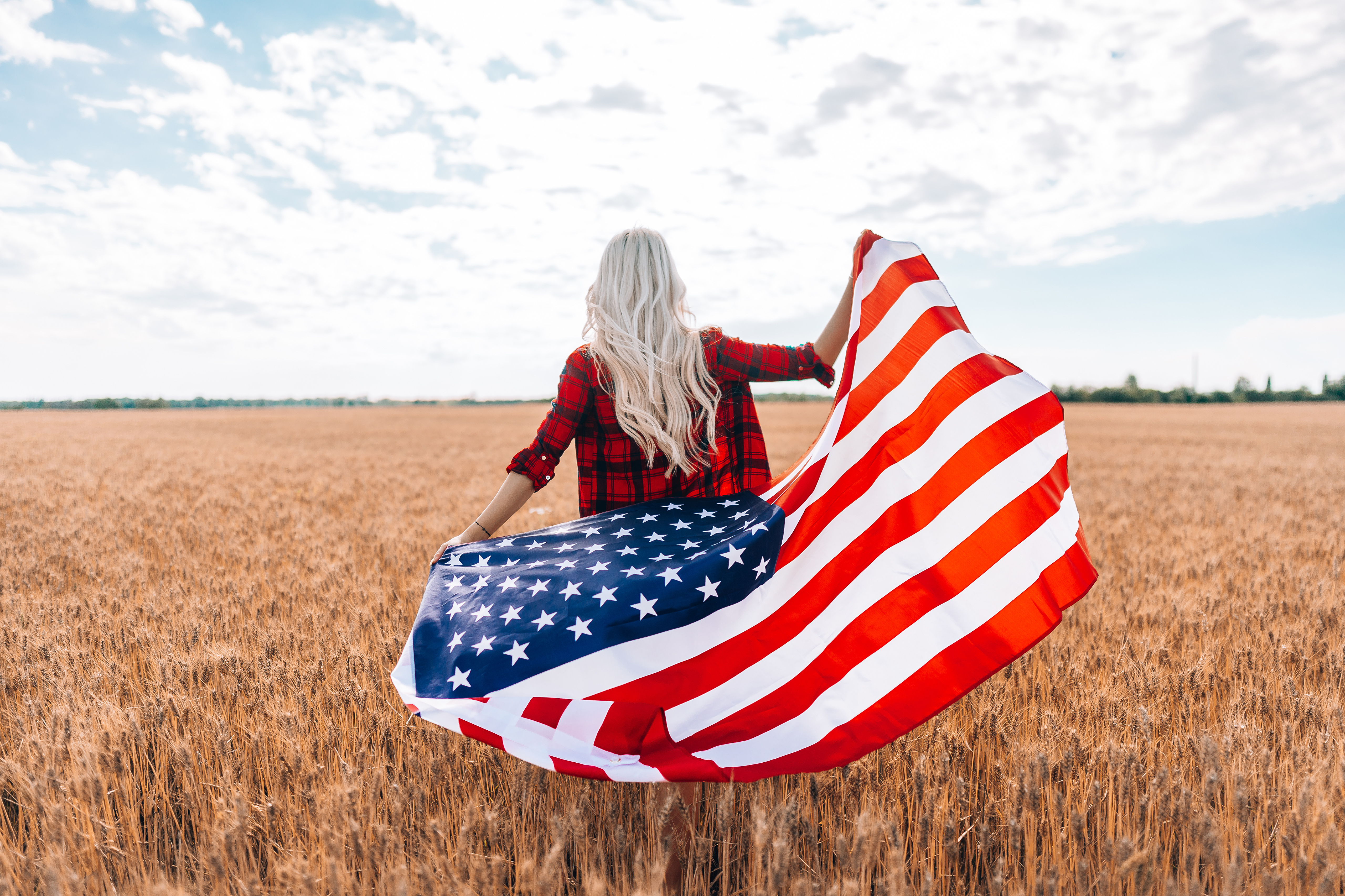 Woman with American Flag in Wheat Field HD Wallpaper