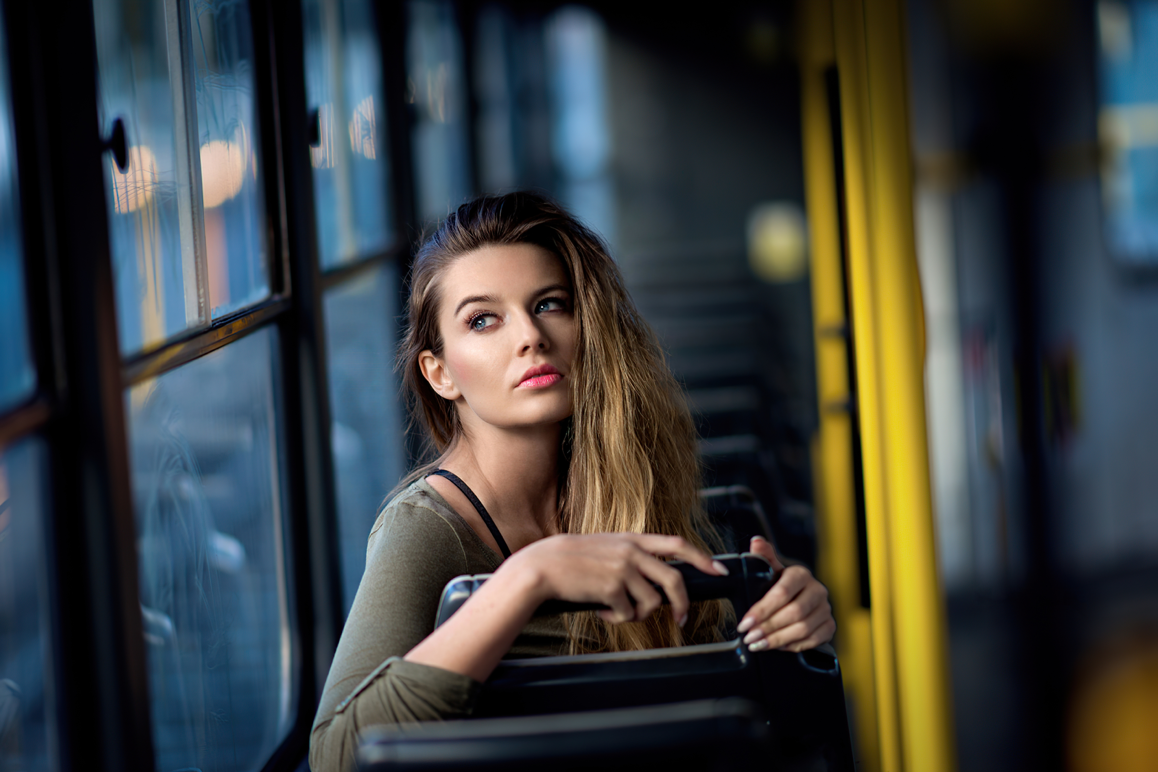 Woman with blonde hair and blue eyes on a bus HD Wallpaper