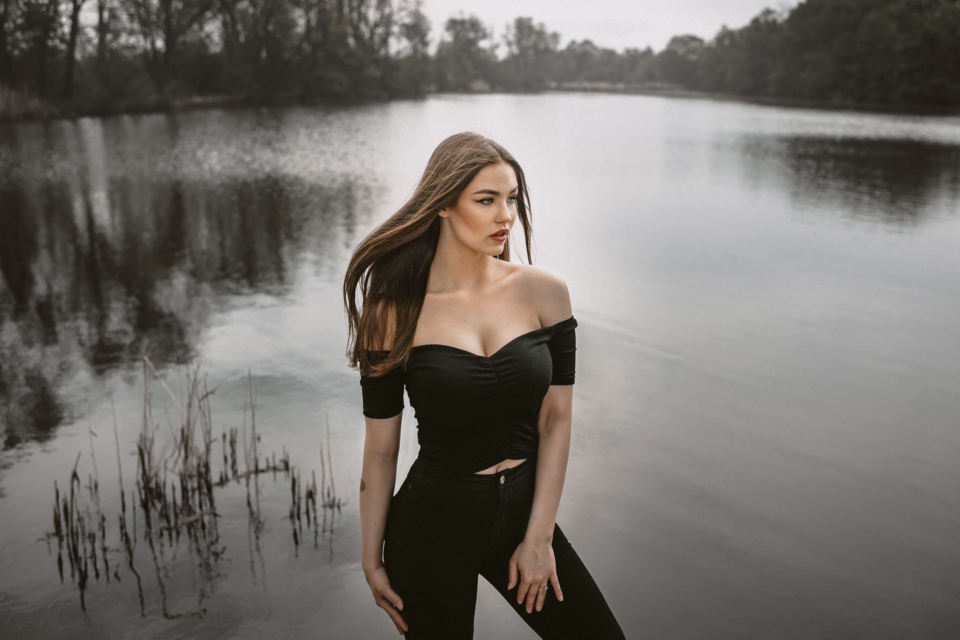 Woman with long brown hair by a lake HD Wallpaper