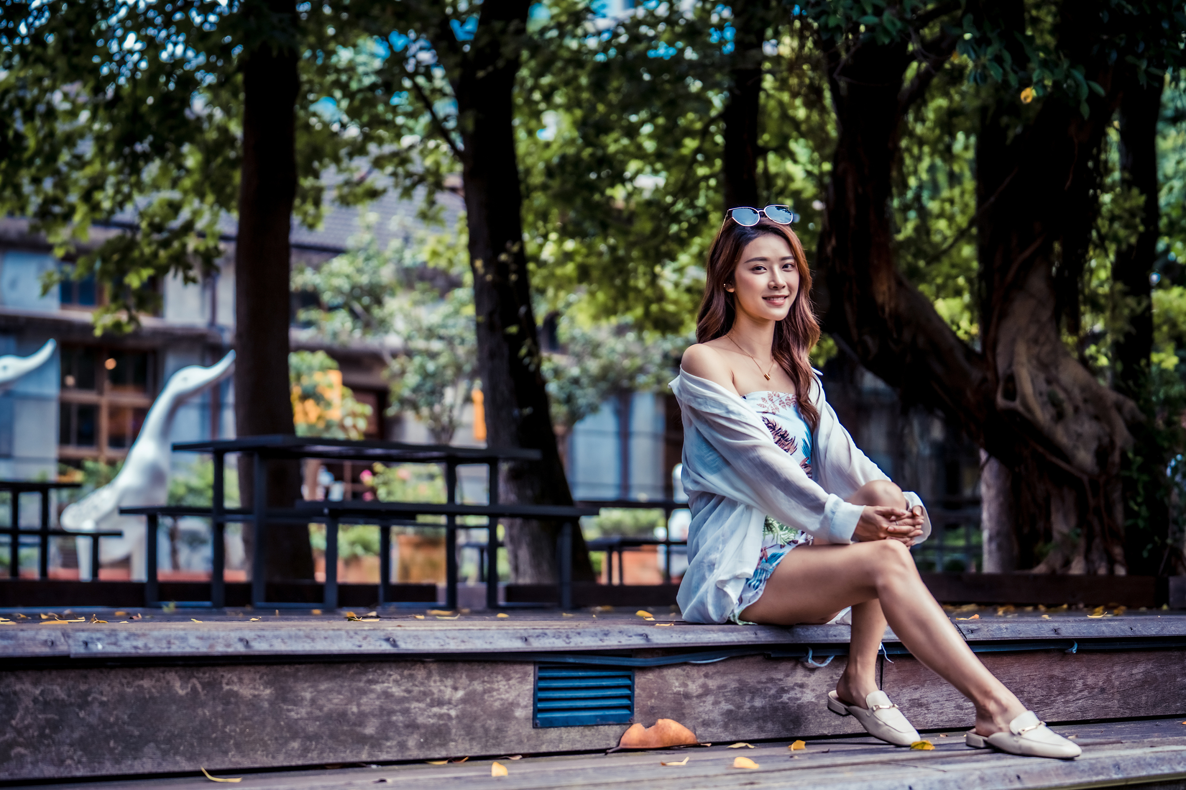 Asian woman with sunglasses sitting on a wooden platform HD Wallpaper