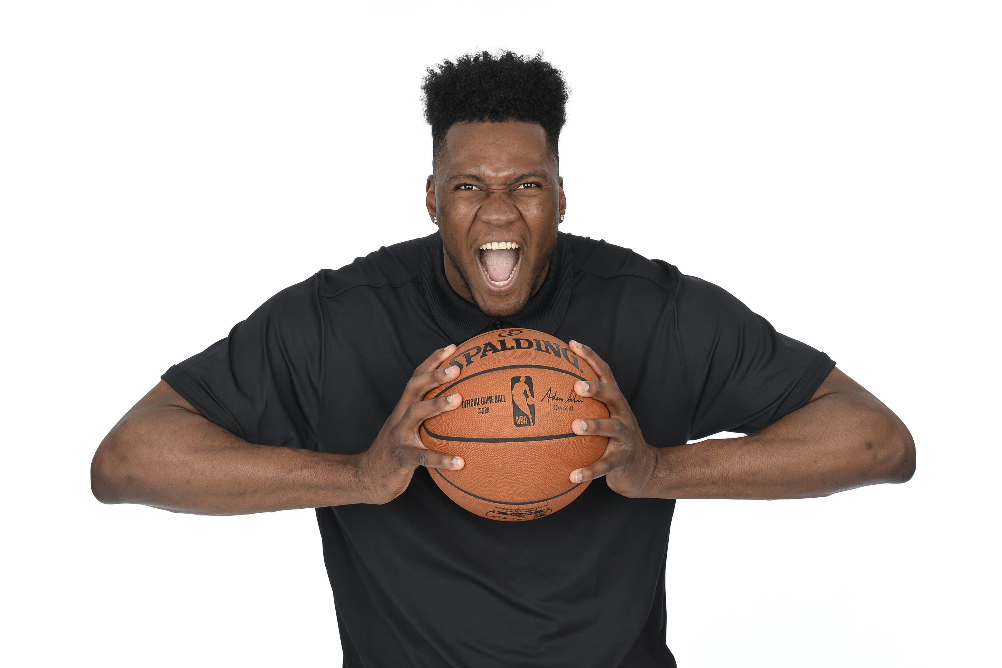 Bruno Fernando holding a Spalding NBA basketball HD Wallpaper
