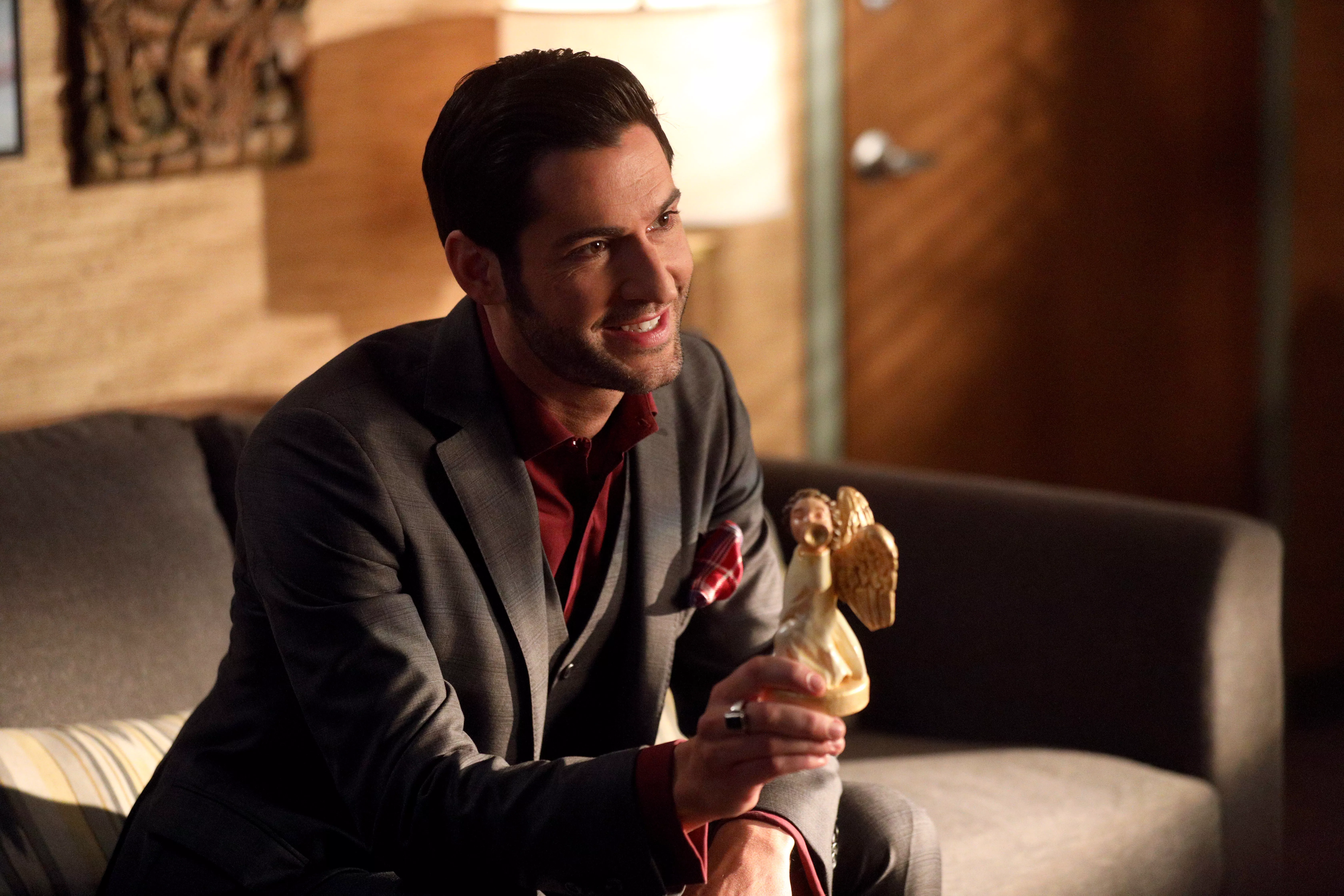 Lucifer Morningstar from Lucifer holding an angel figurine HD Wallpaper