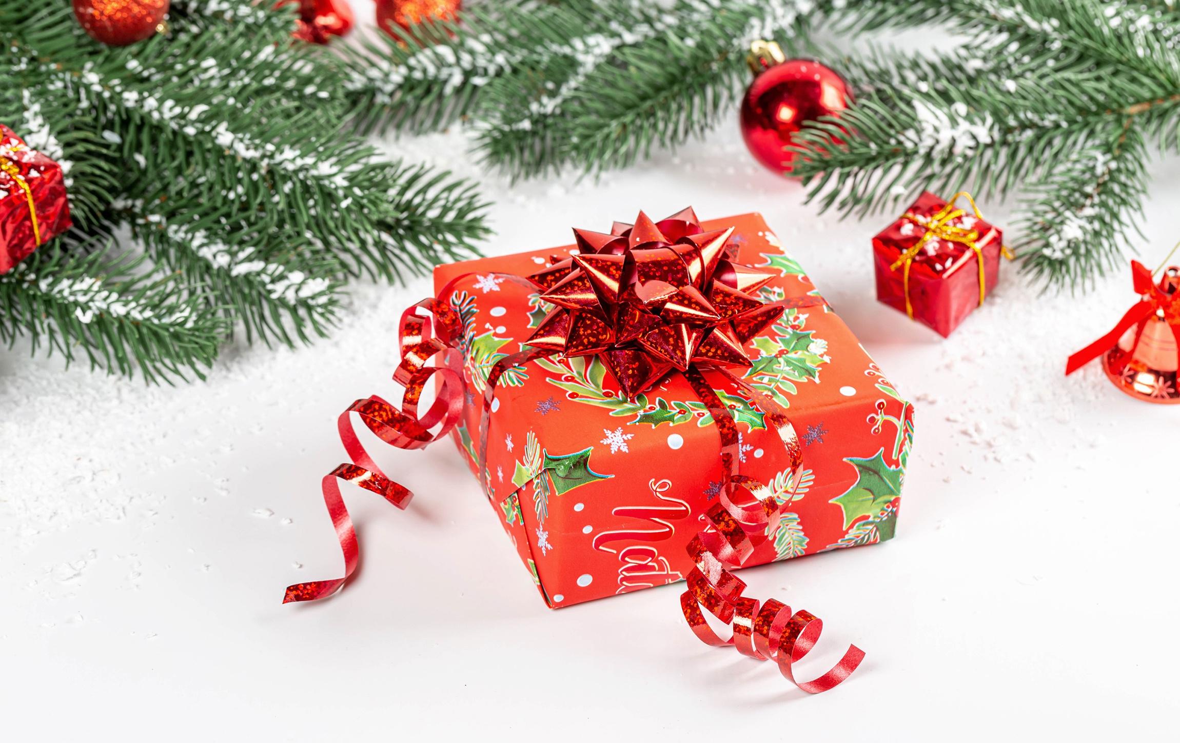 Christmas gift with ornaments and pine branches HD Wallpaper