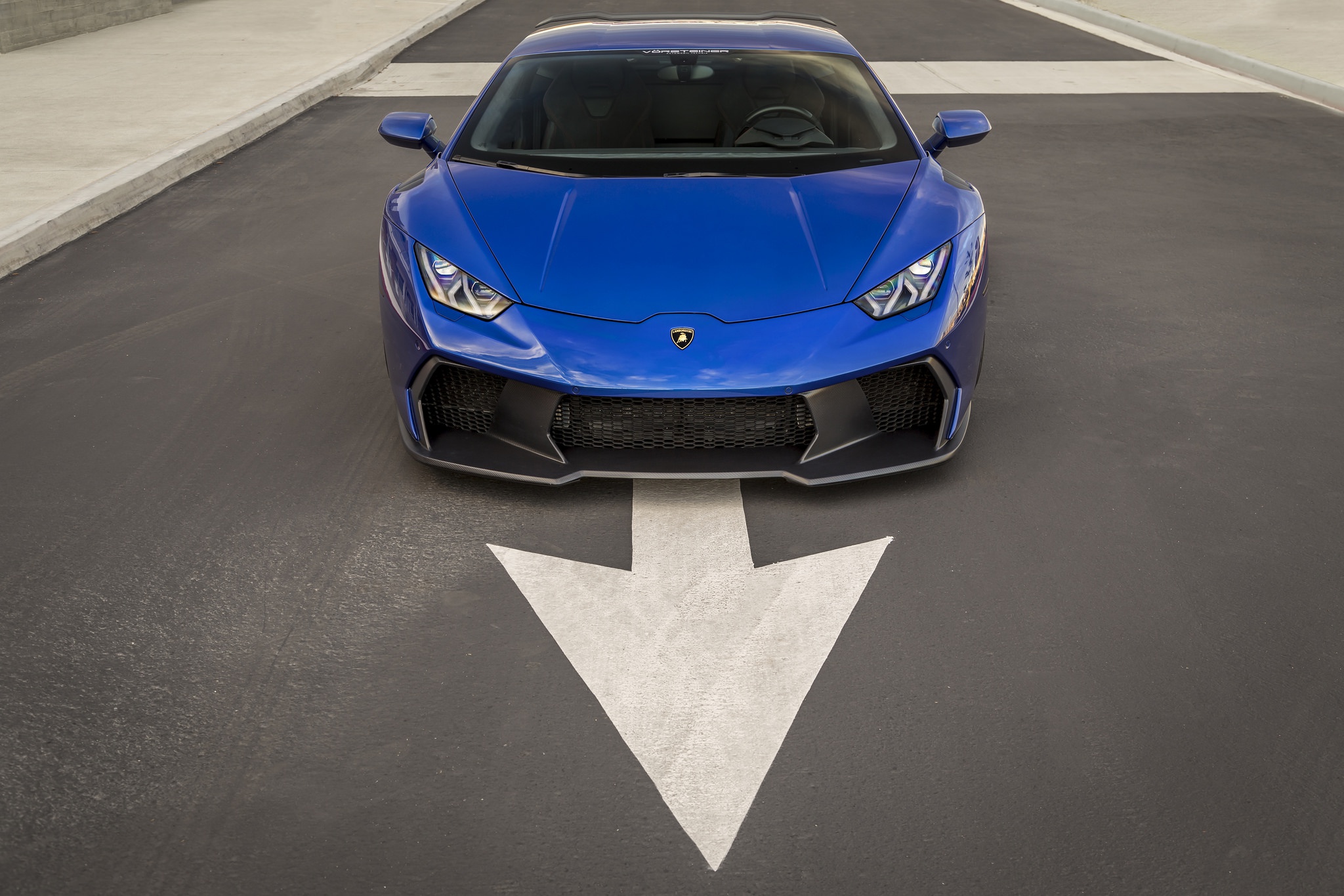 Blue Lamborghini Huracan parked on asphalt with arrow marking HD Wallpaper