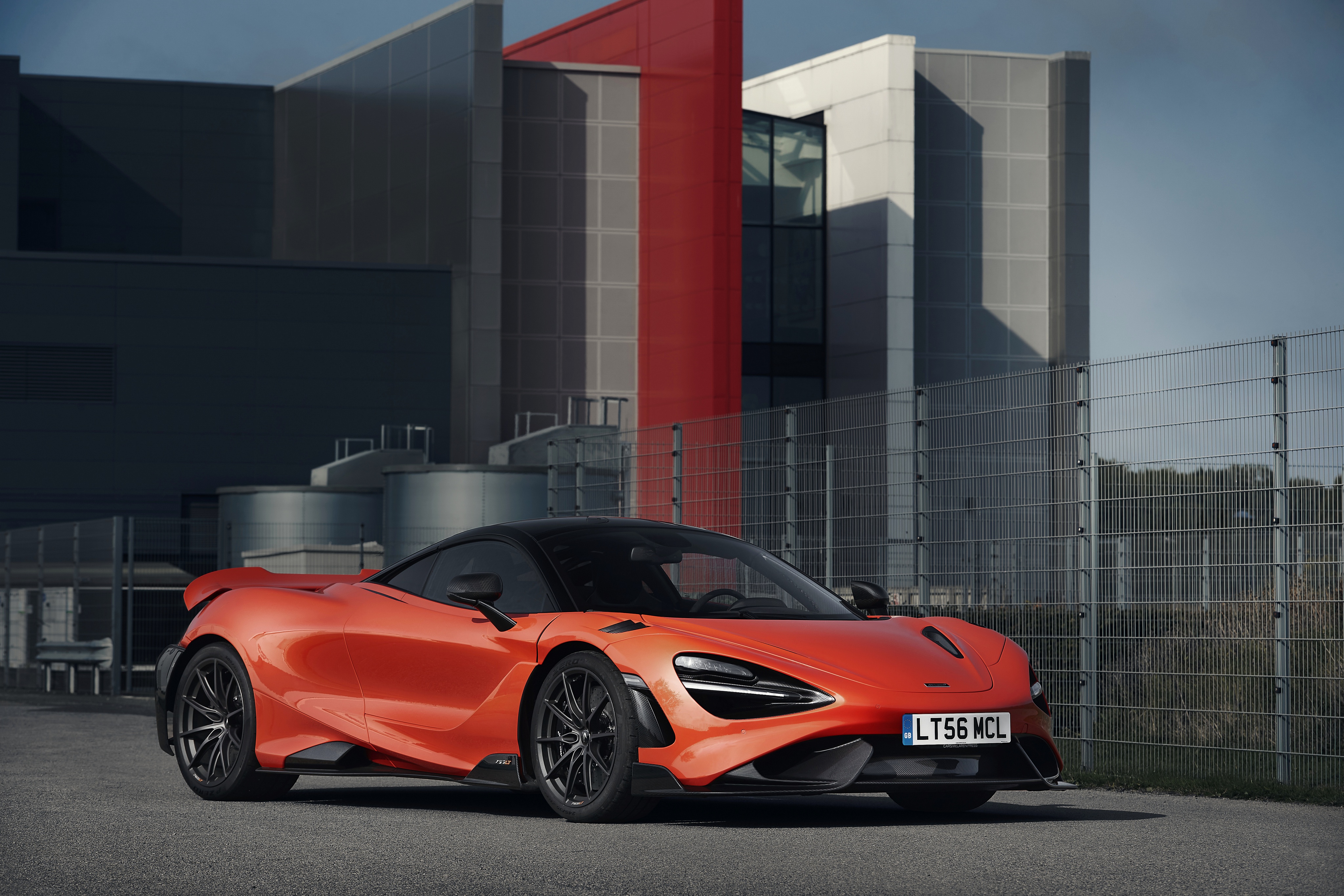 McLaren 765LT supercar parked in front of modern building HD Wallpaper