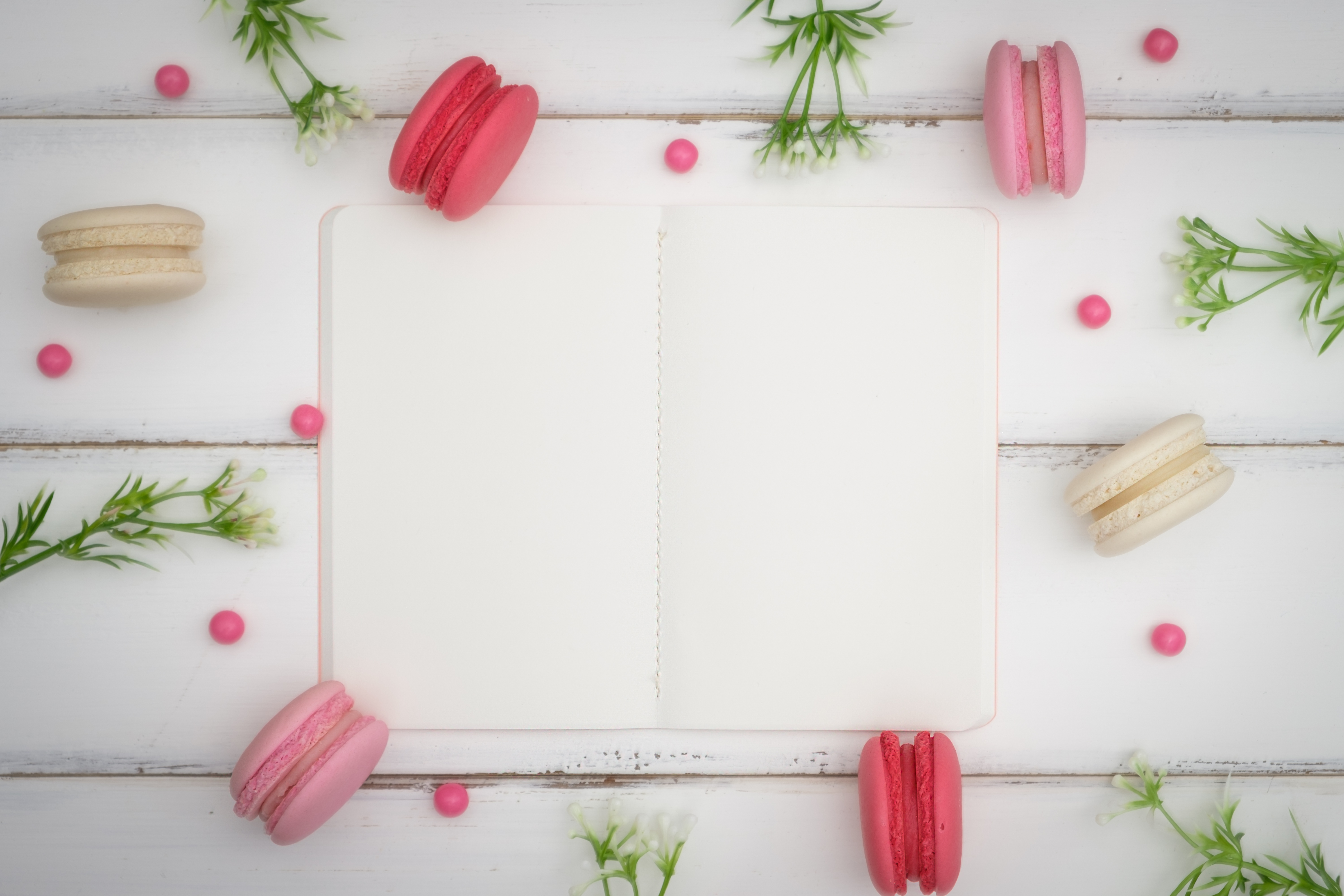 Macarons and notebook on a wooden table HD Wallpaper
