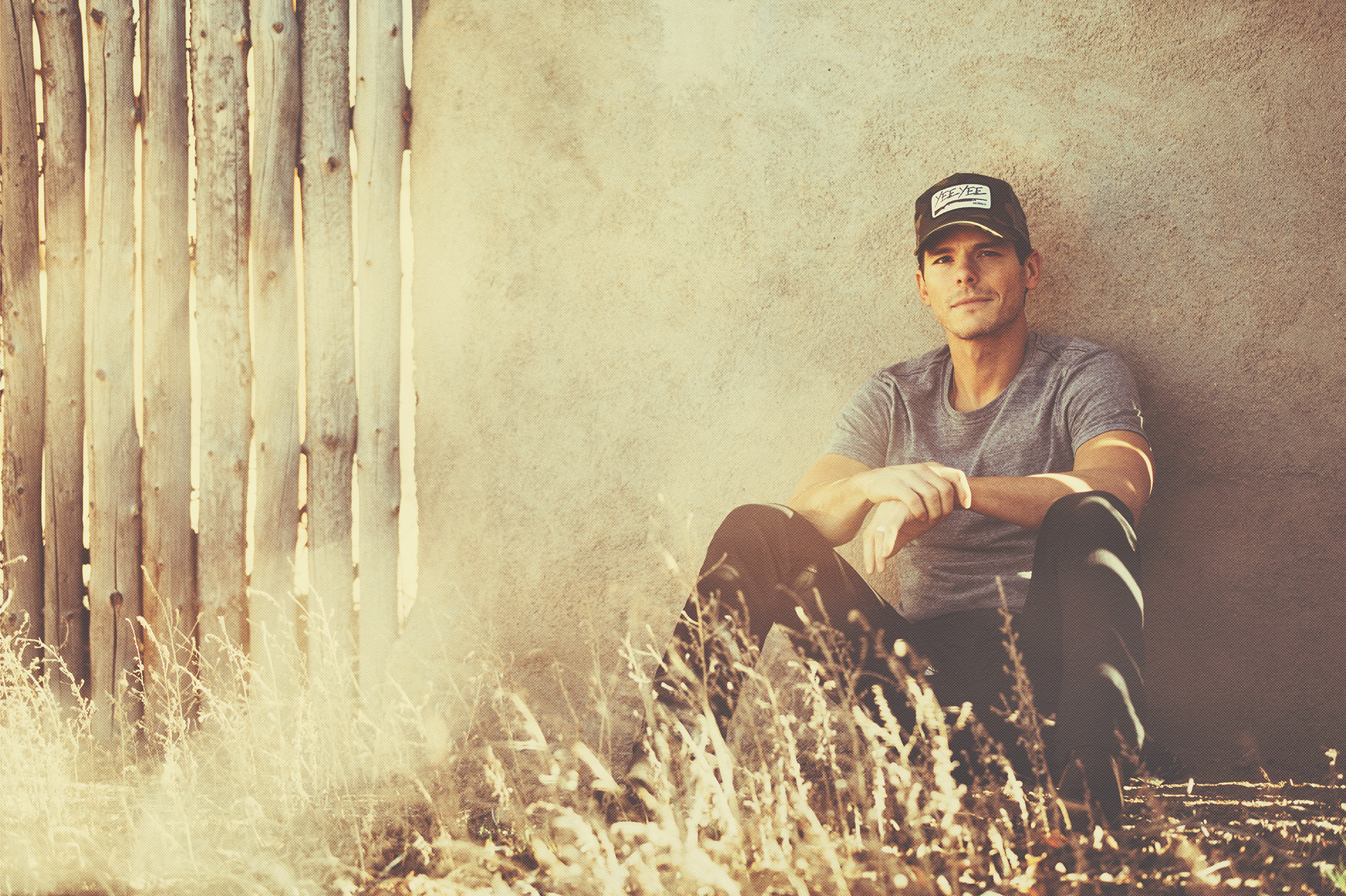 Granger Smith sitting by a fence and wall HD Wallpaper