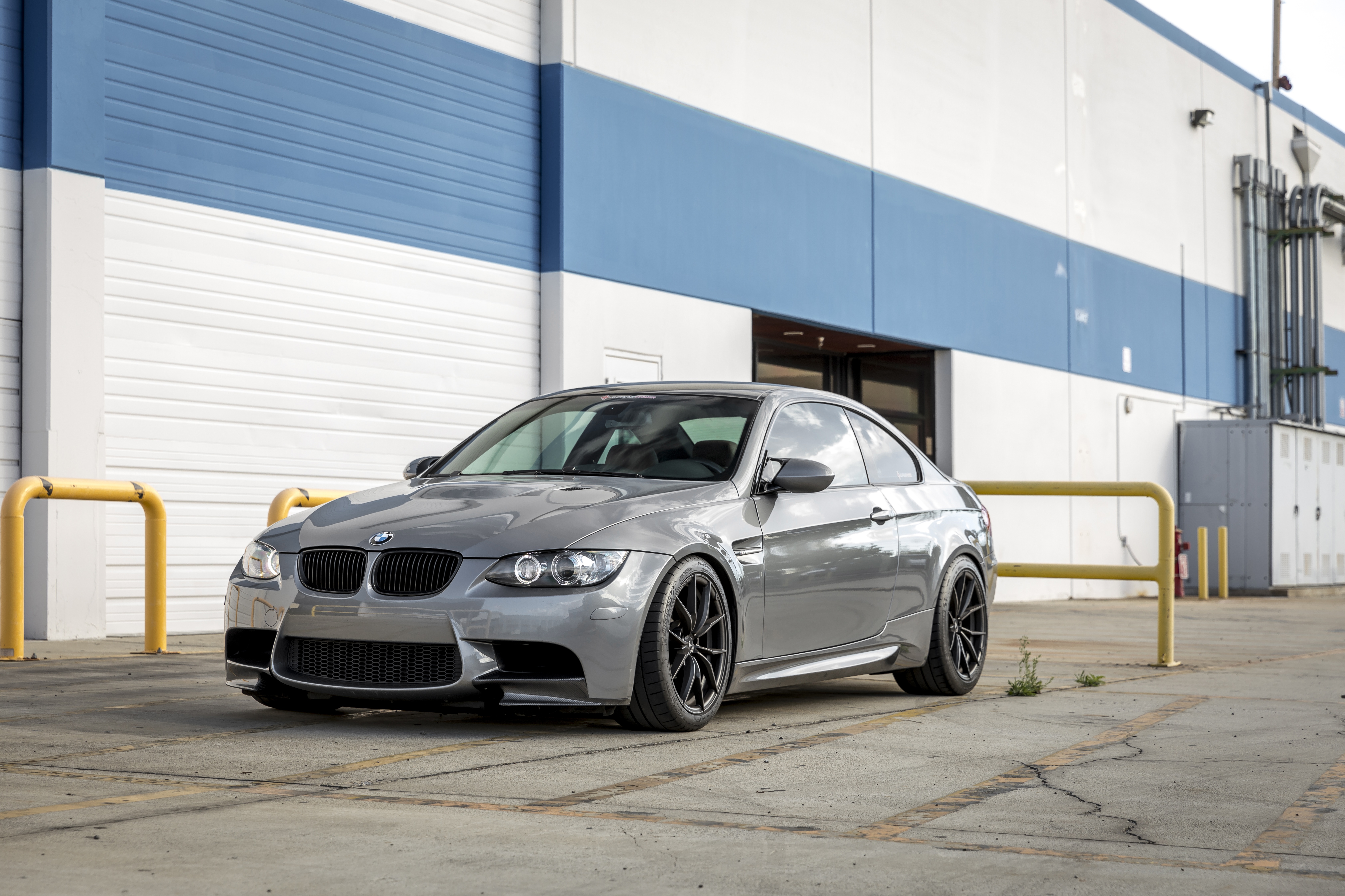 Silver BMW M3 Coupe parked outside building HD Wallpaper