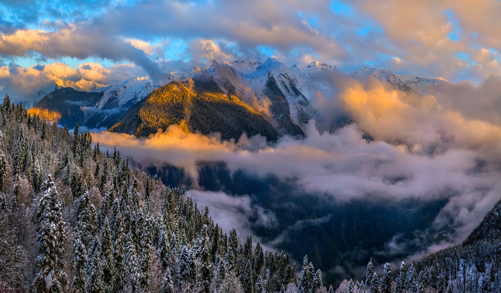 Snowy Mountains with Clouds at Sunset HD Wallpaper