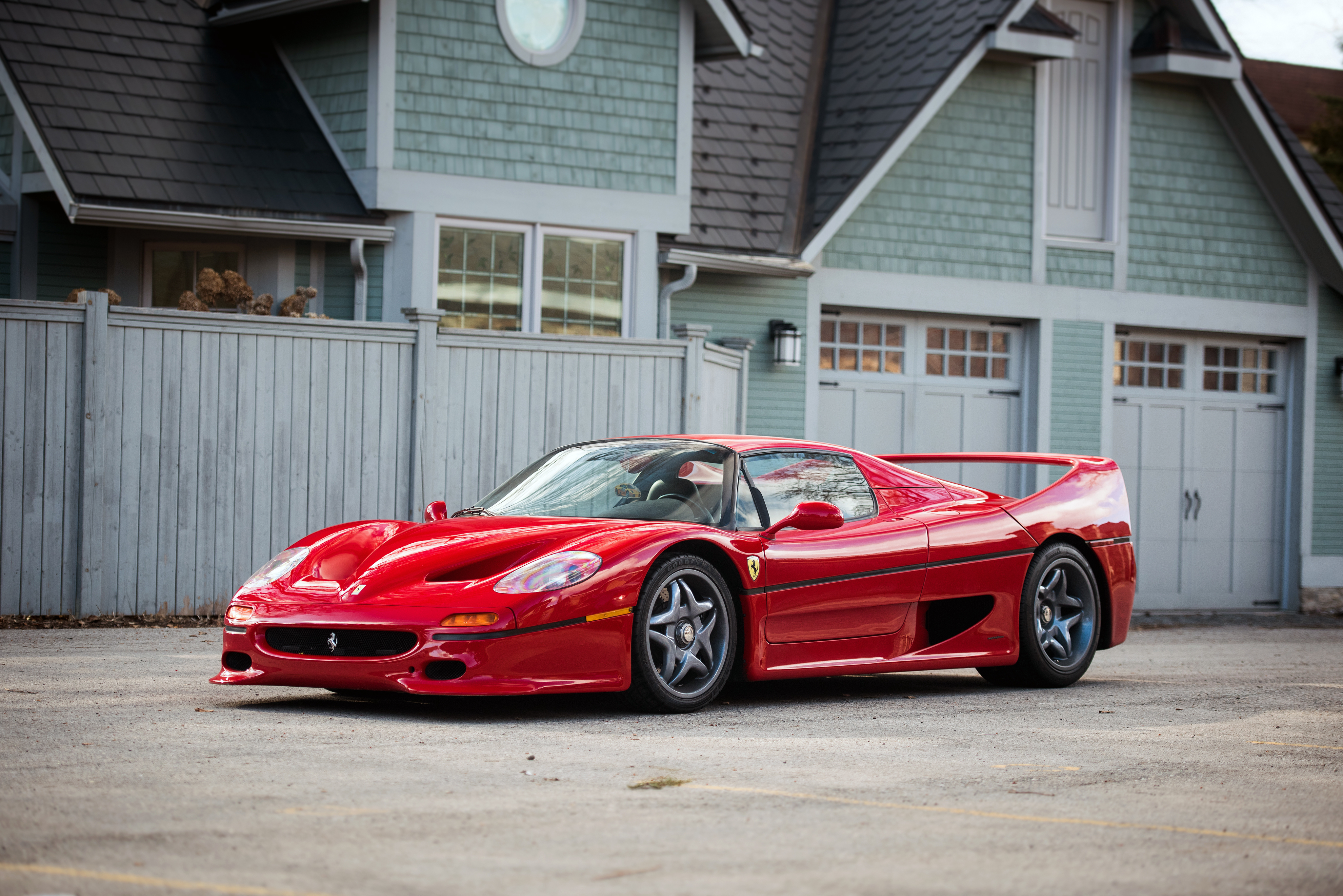 Red Ferrari F50 Supercar parked in front of a house HD Wallpaper
