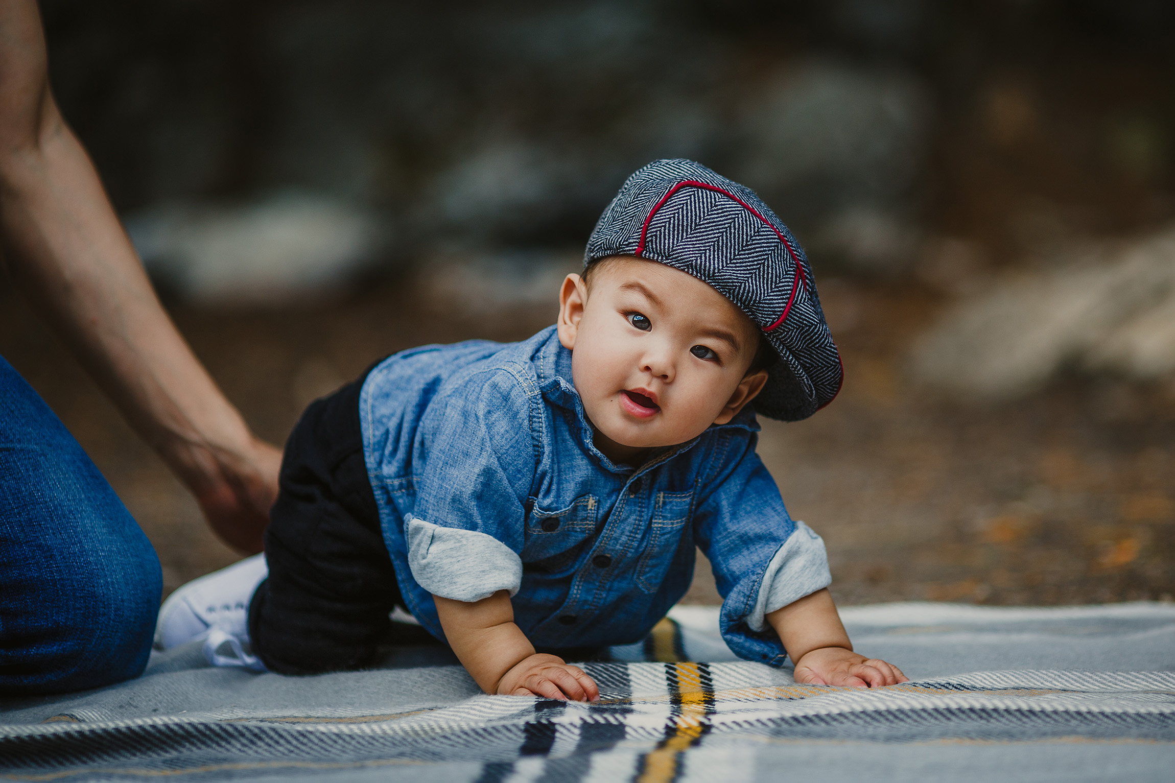 Baby boy in denim shirt and cap crawling on blanket HD Wallpaper