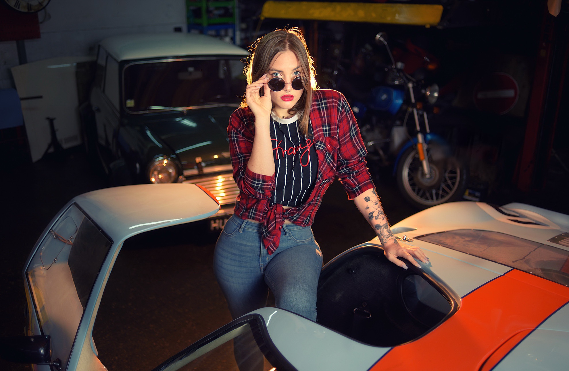 Woman with sunglasses and tattoos leaning on a sports car HD Wallpaper