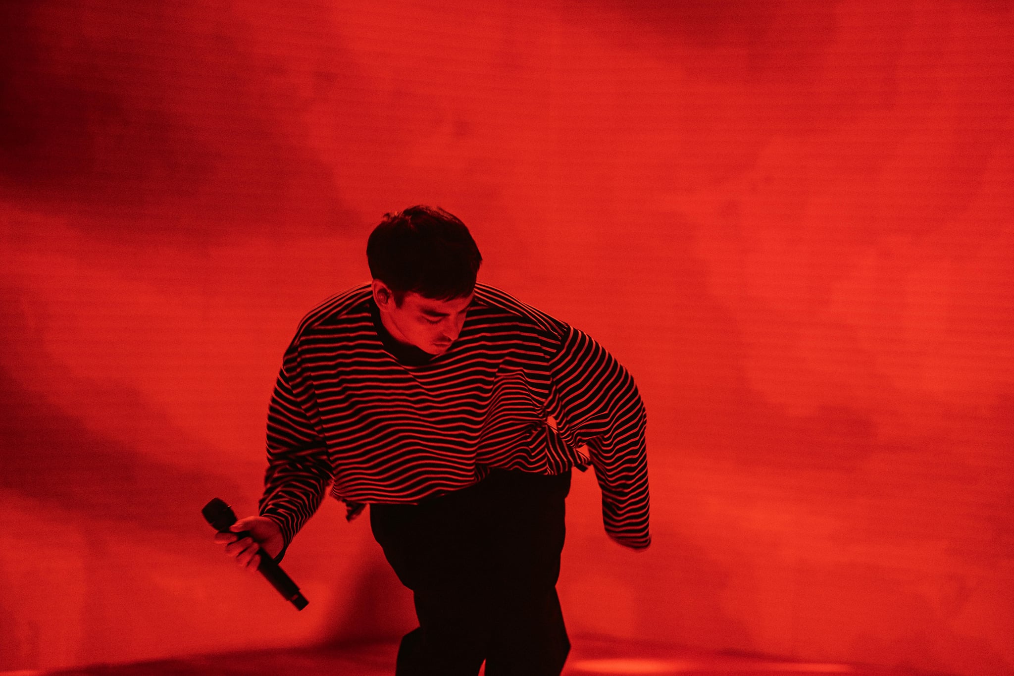 Joji performing on a red stage HD Wallpaper