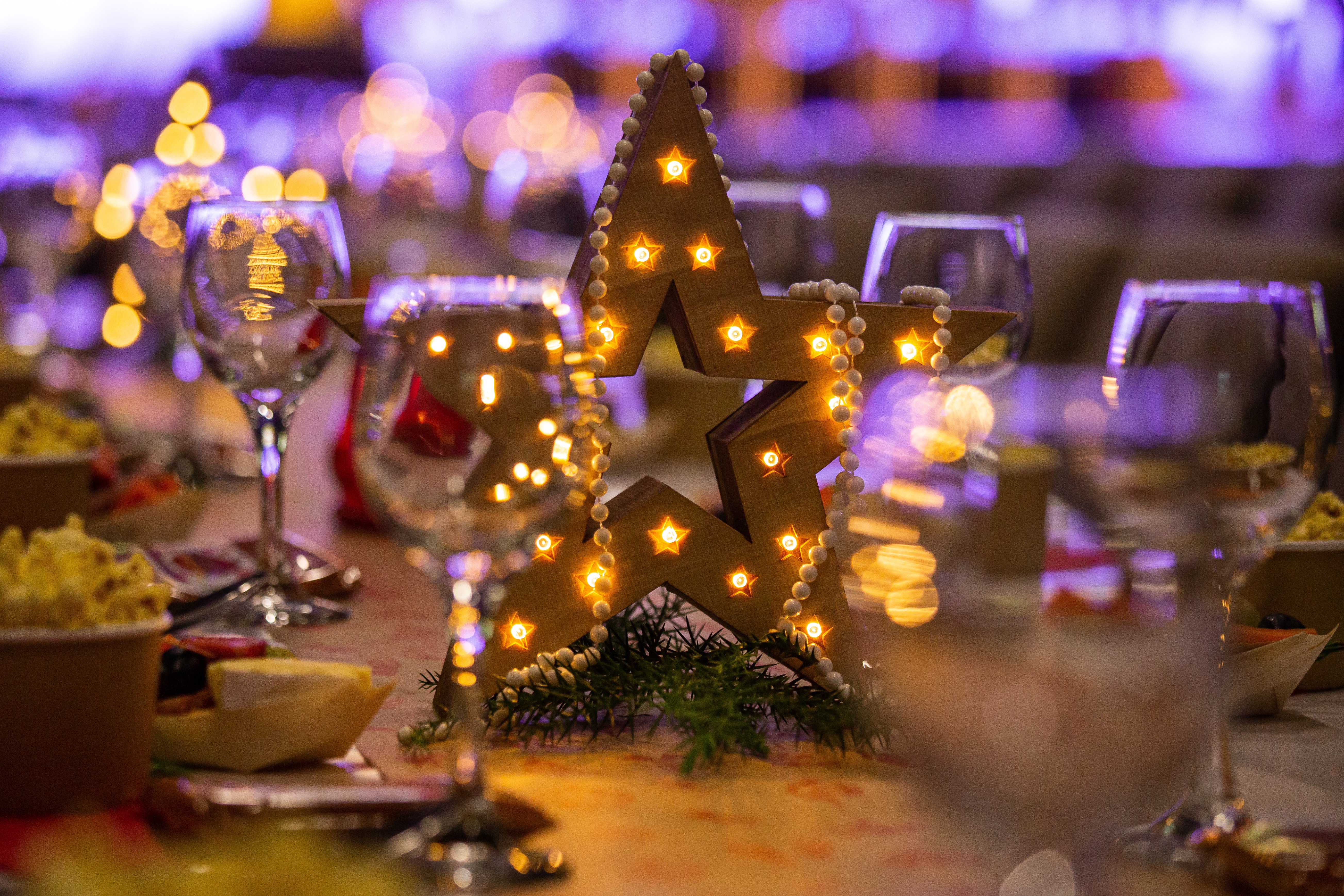 Christmas star decoration with lights on a table HD Wallpaper