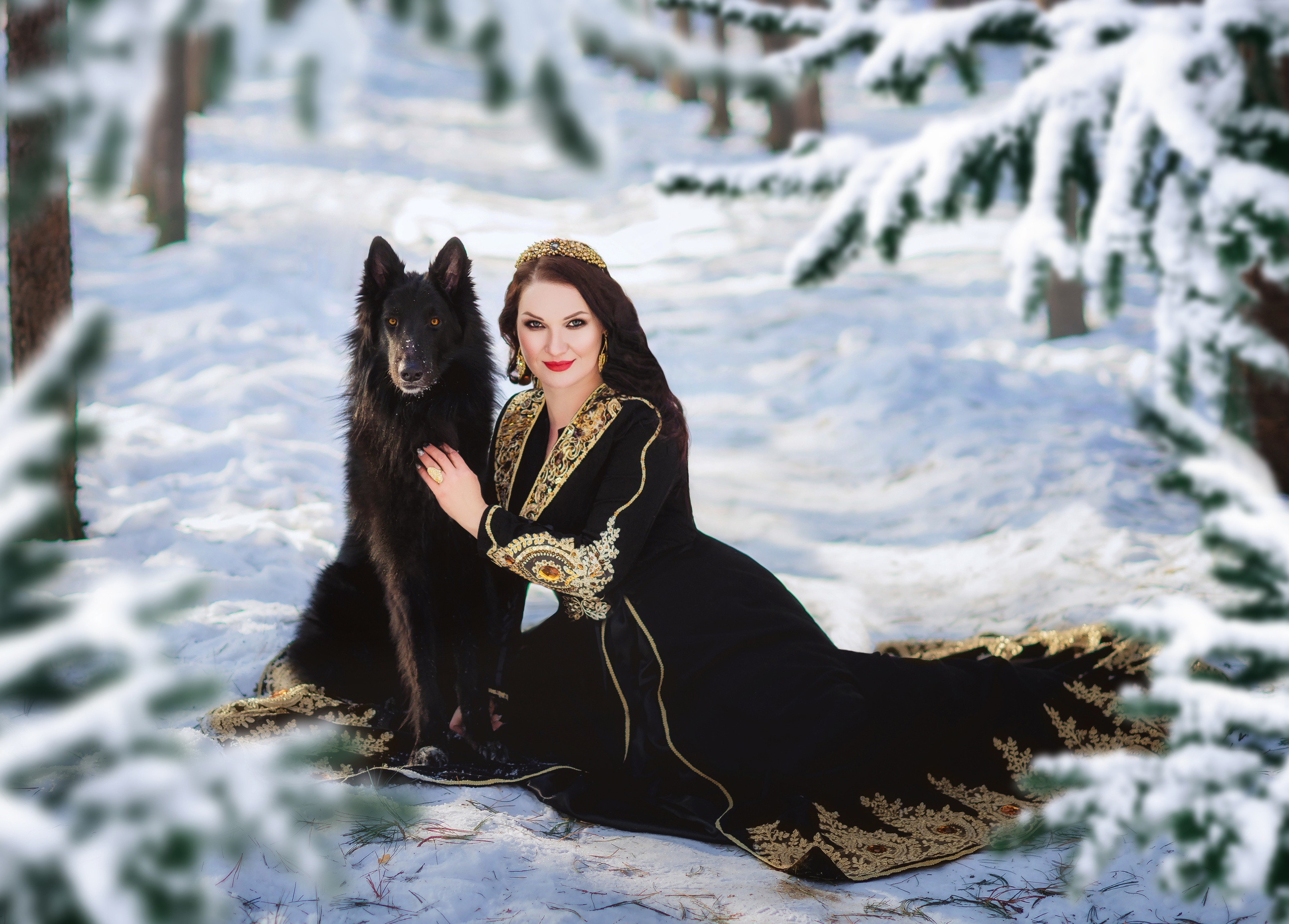 Woman in black dress with dog in snowy forest HD Wallpaper