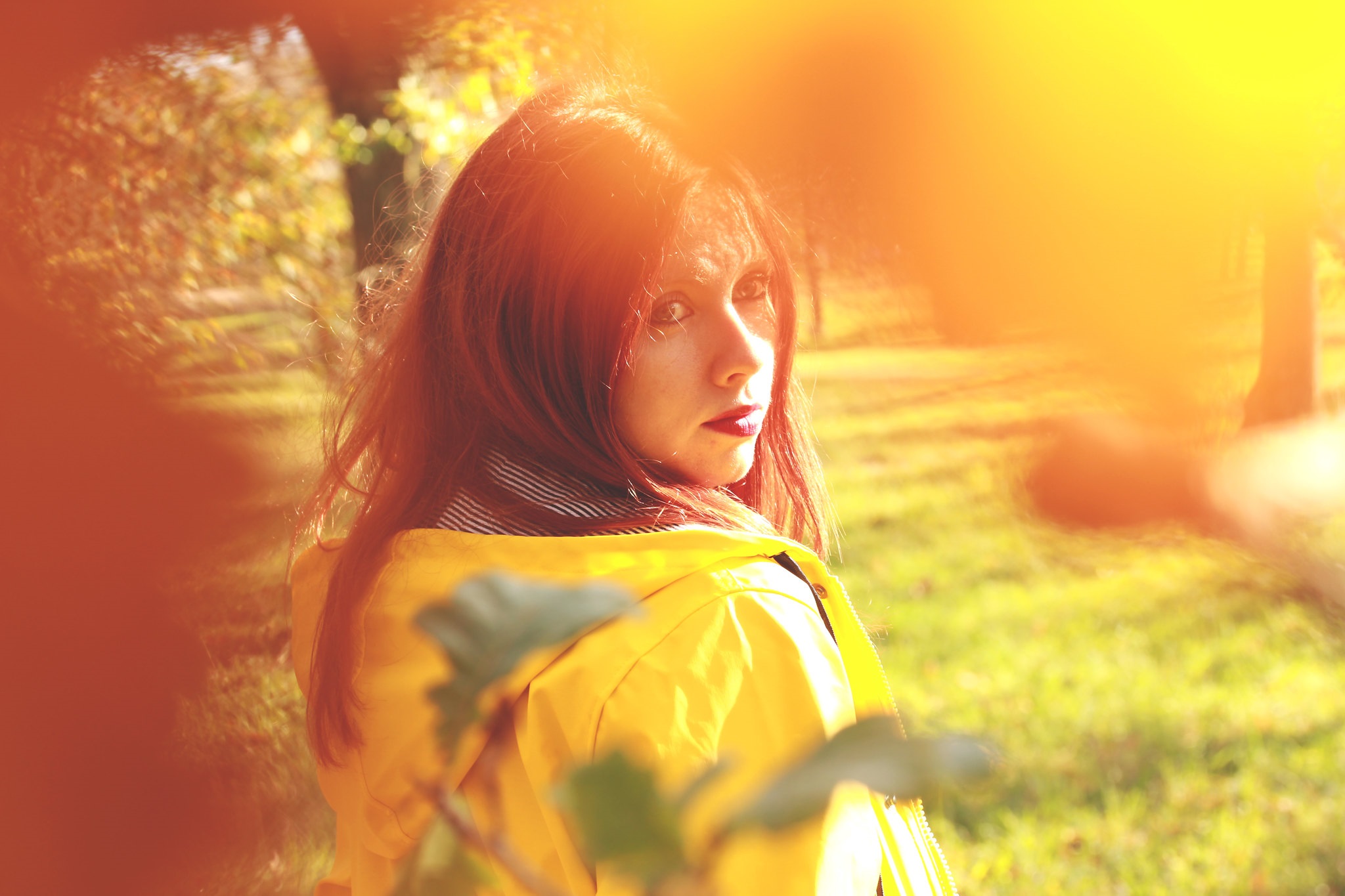 Woman in yellow raincoat in park HD Wallpaper
