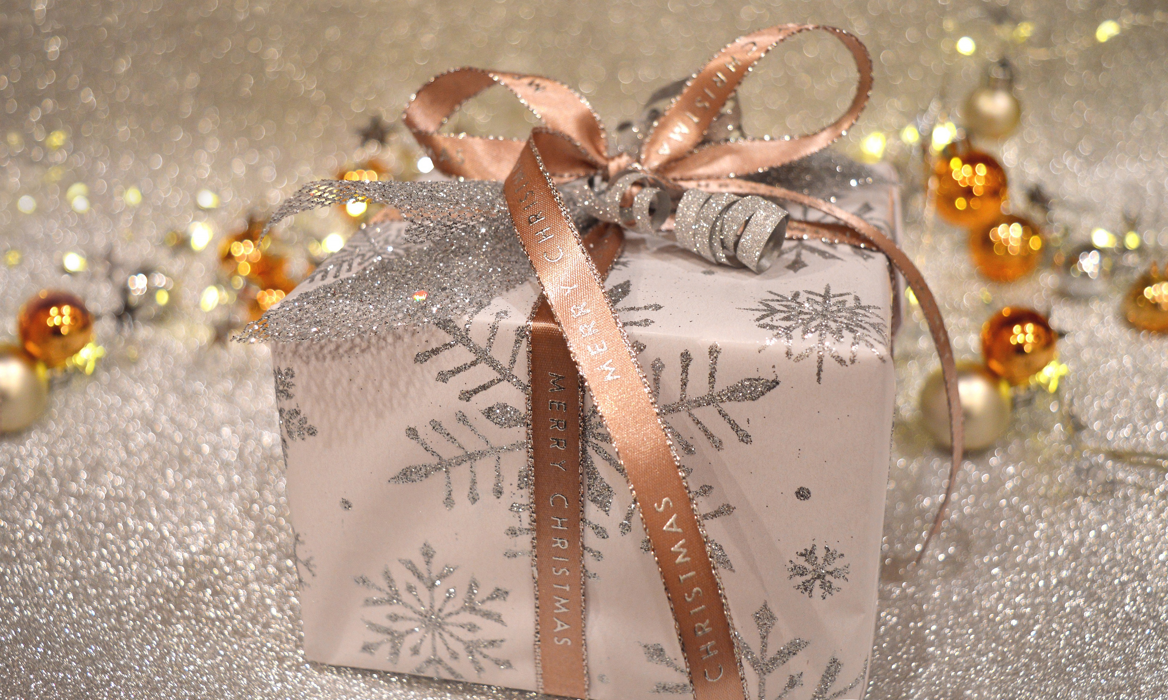 Christmas Gift with Snowflake Wrapping and "Merry Christmas" Ribbon HD Wallpaper