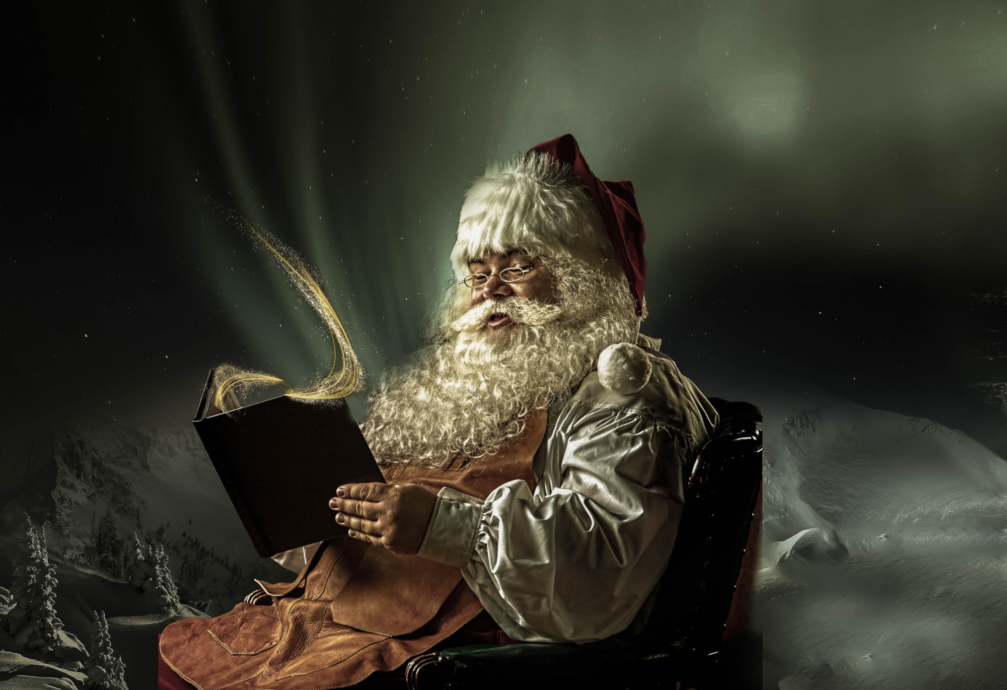 Santa Claus reading a magical book in a snowy landscape HD Wallpaper