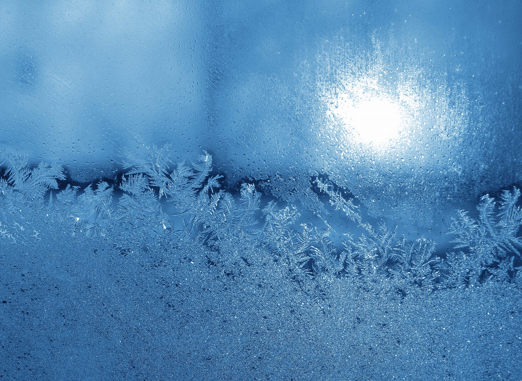 Frost patterns on a window with sunlight HD Wallpaper