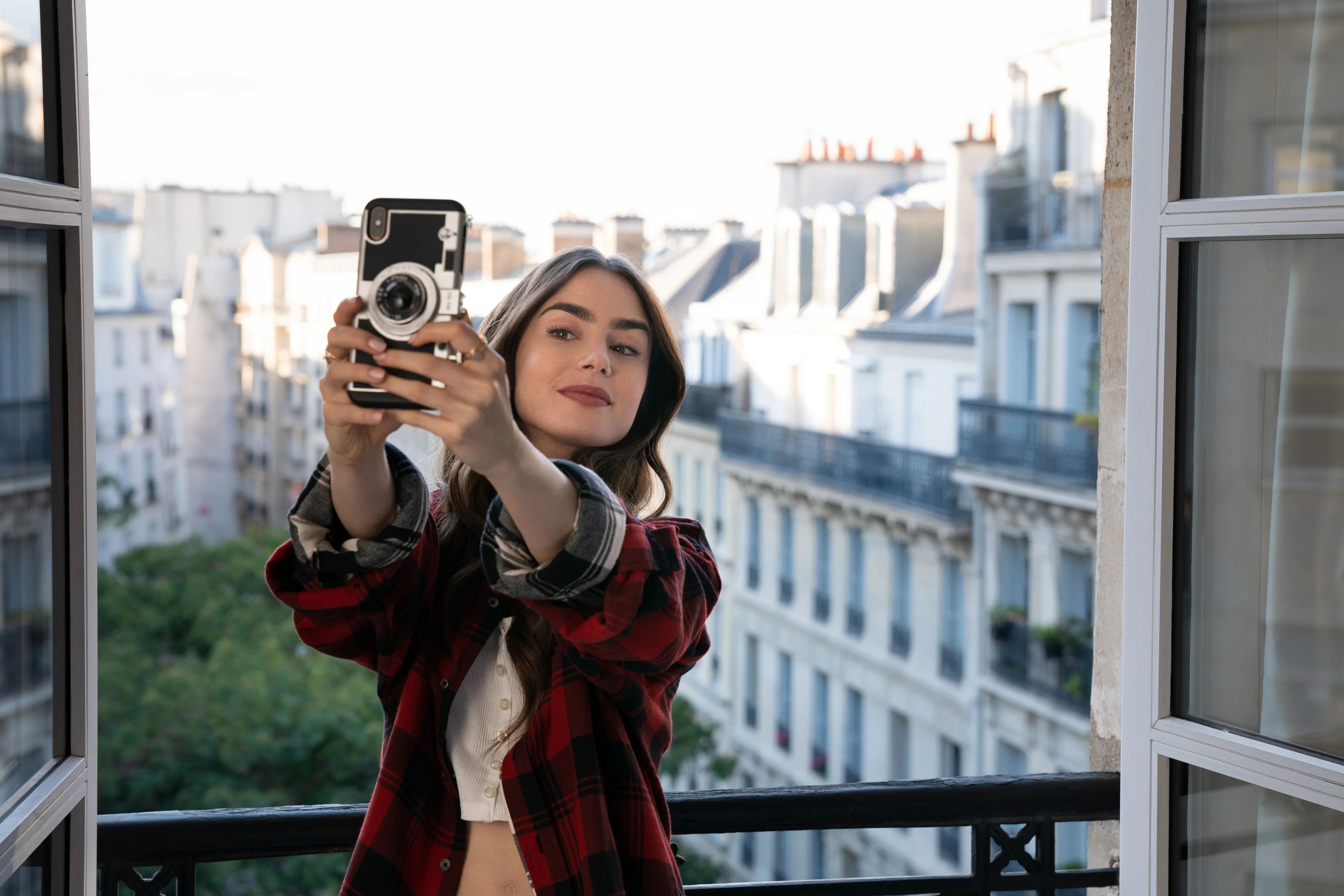Lily Collins taking a selfie with a camera phone HD Wallpaper