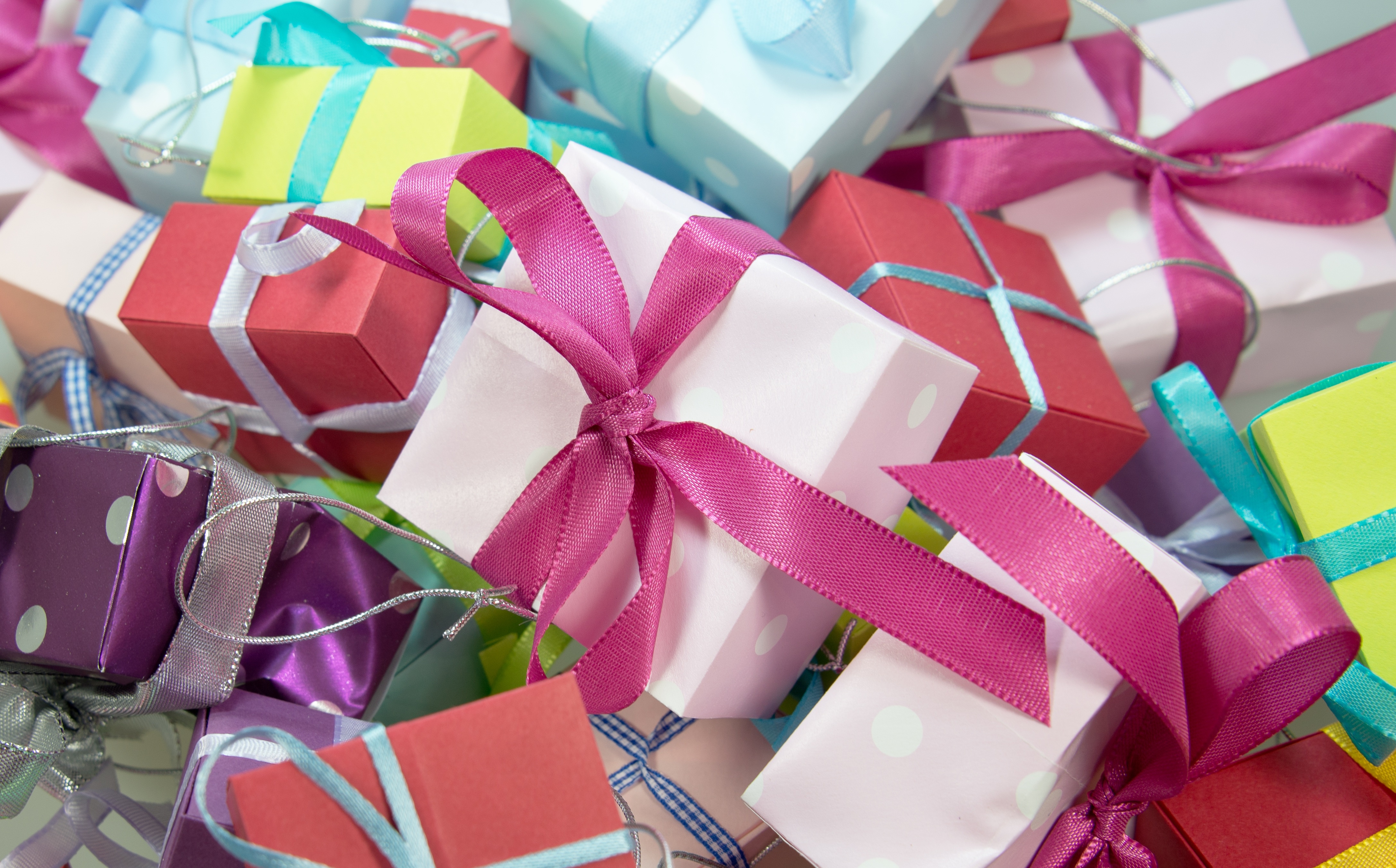 Pile of colorful gift boxes with ribbons HD Wallpaper