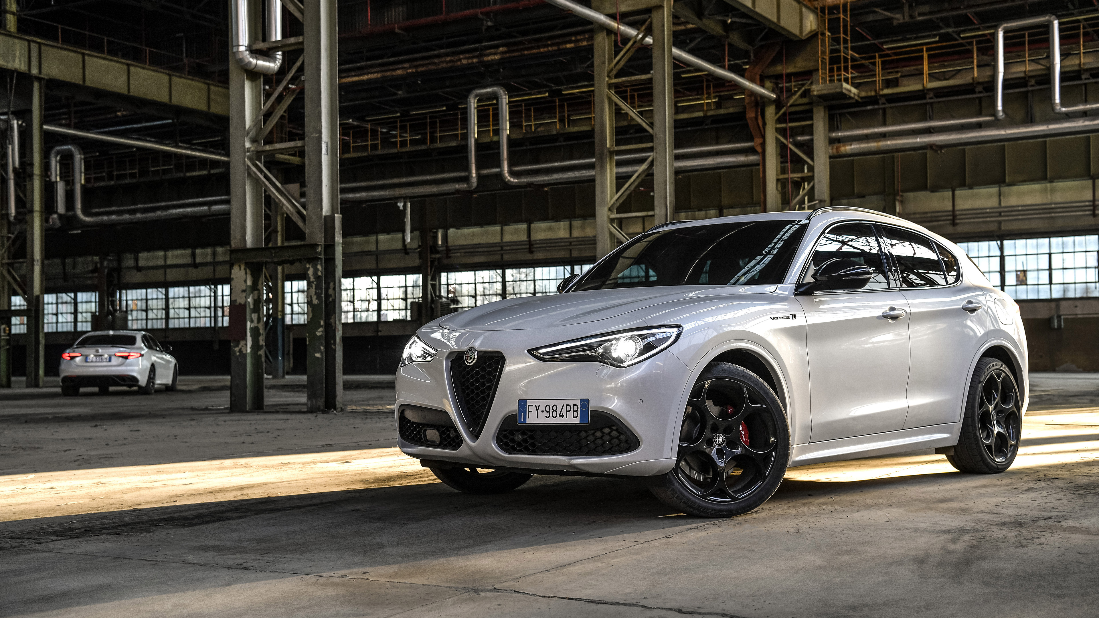 White Alfa Romeo Stelvio Veloce Ti SUV in industrial building HD Wallpaper