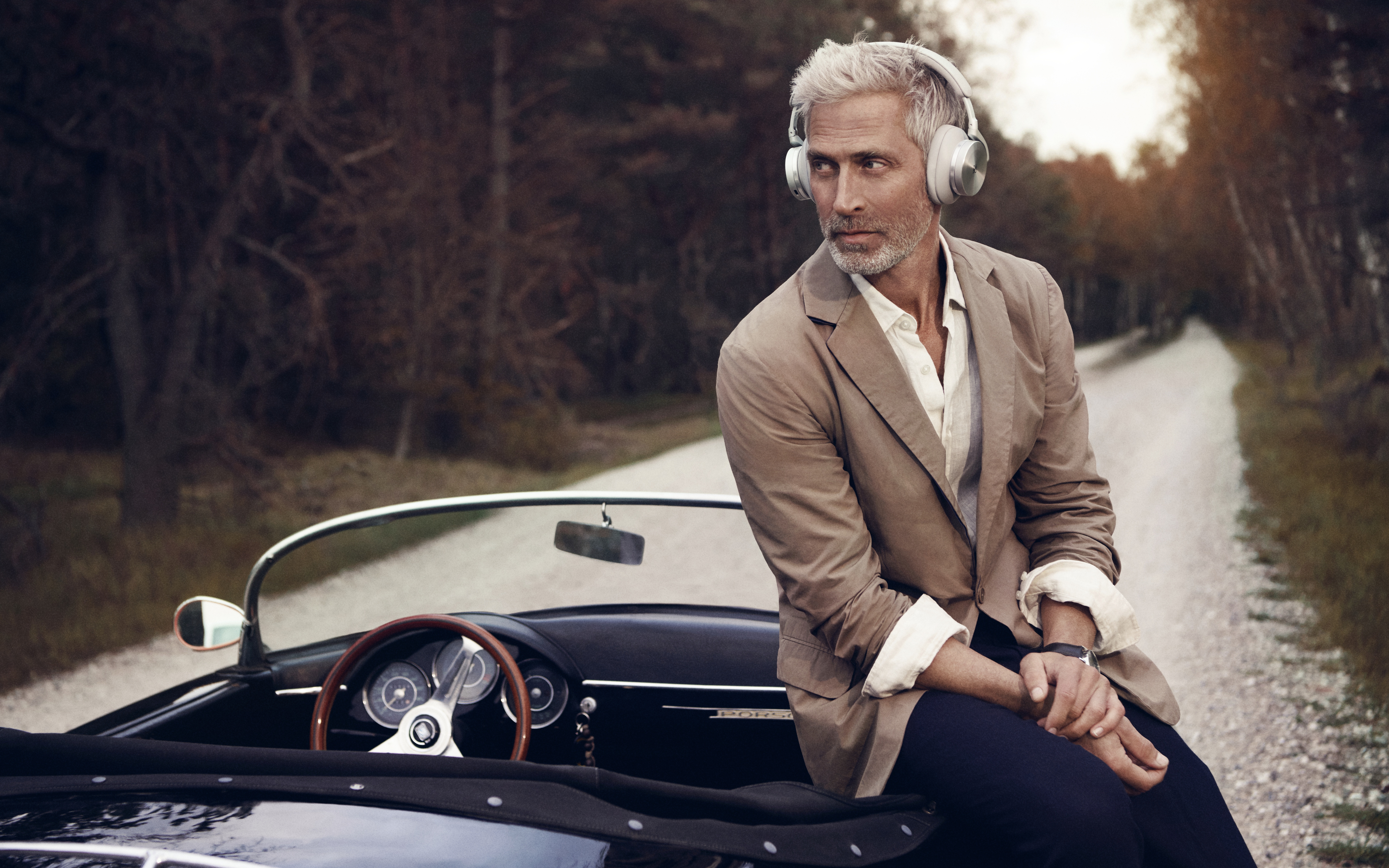 Man with headphones sitting on a vintage car HD Wallpaper