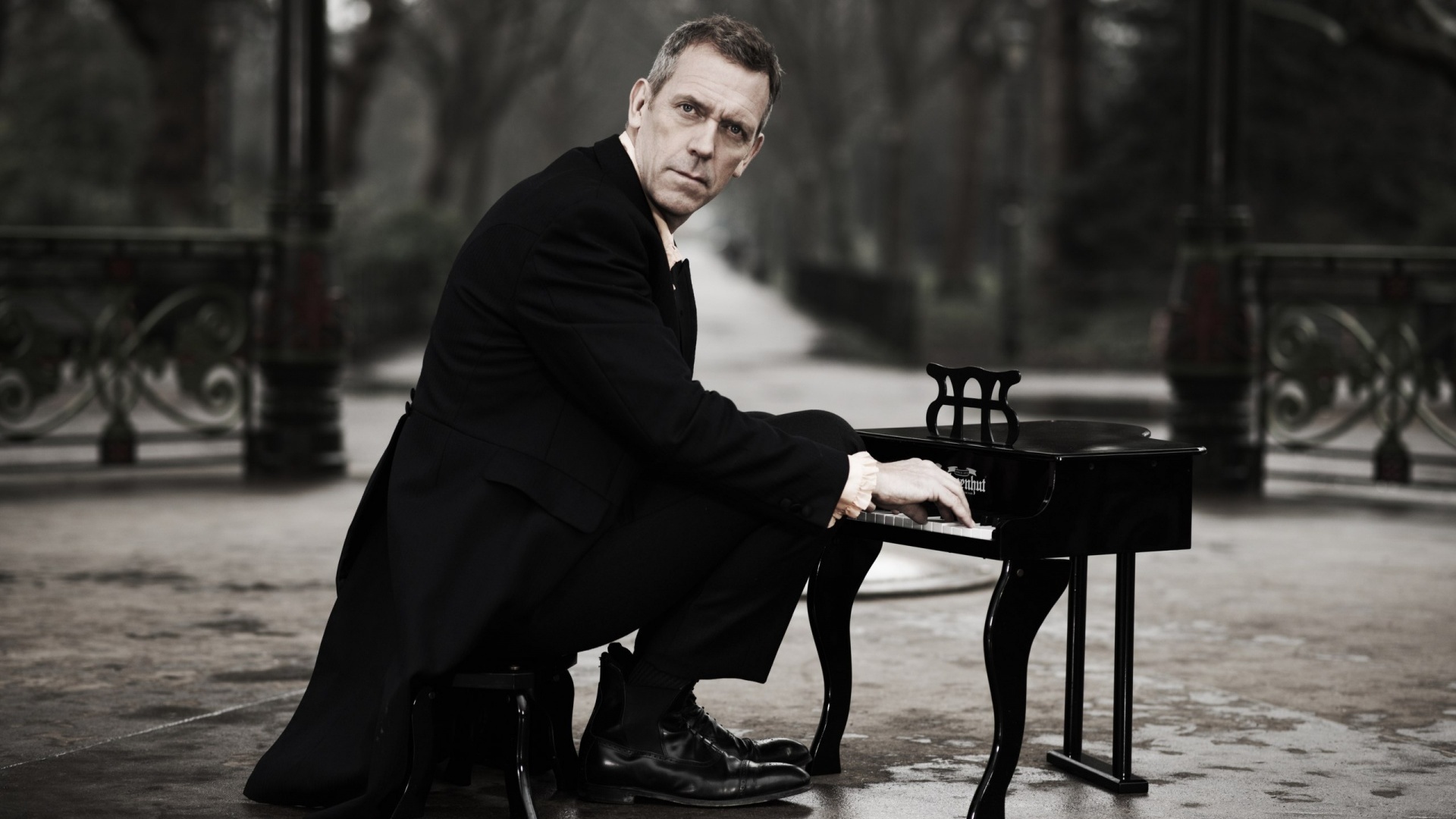 Hugh Laurie playing a small piano HD Wallpaper