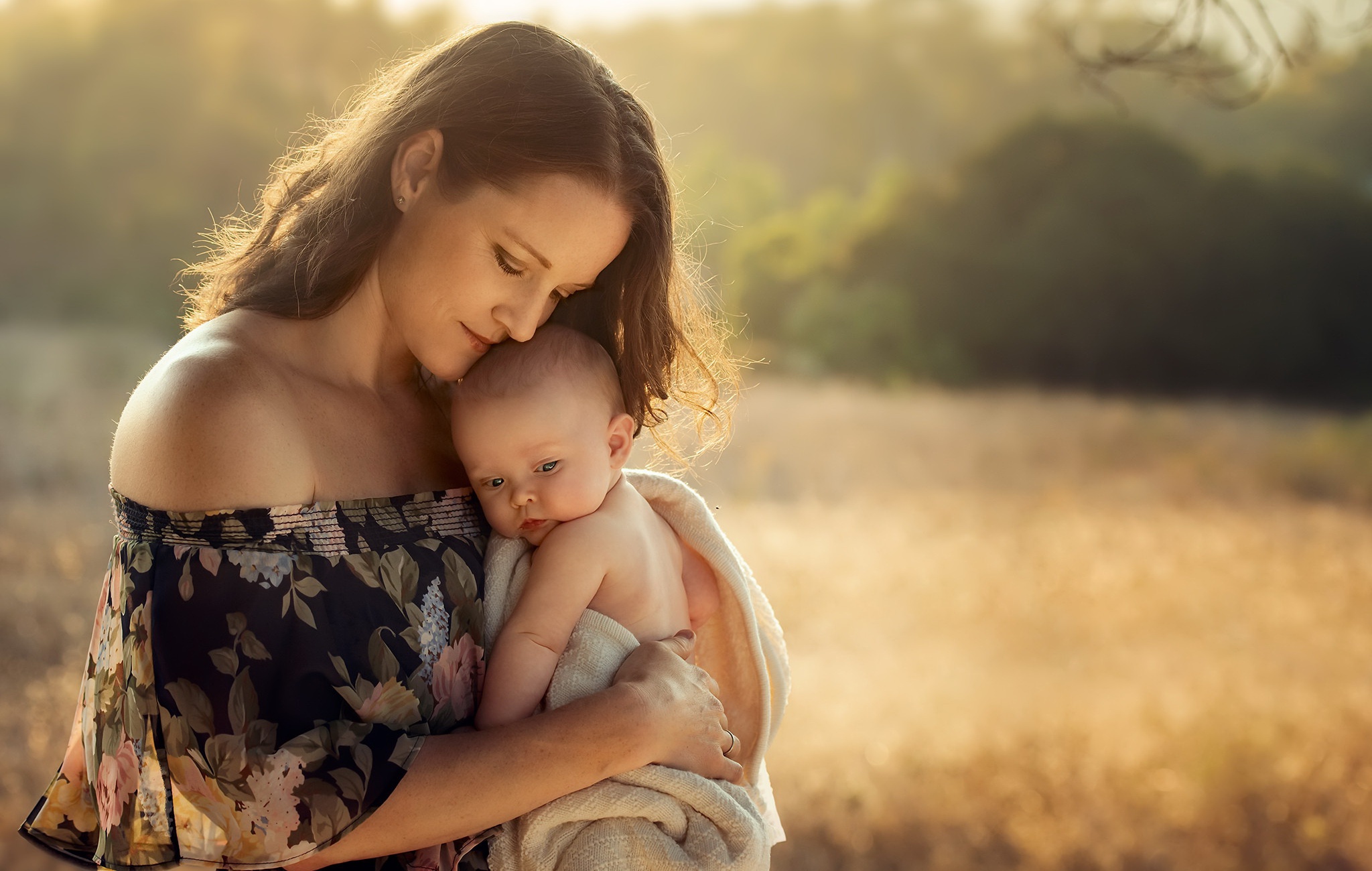 Mother holding a baby HD Wallpaper