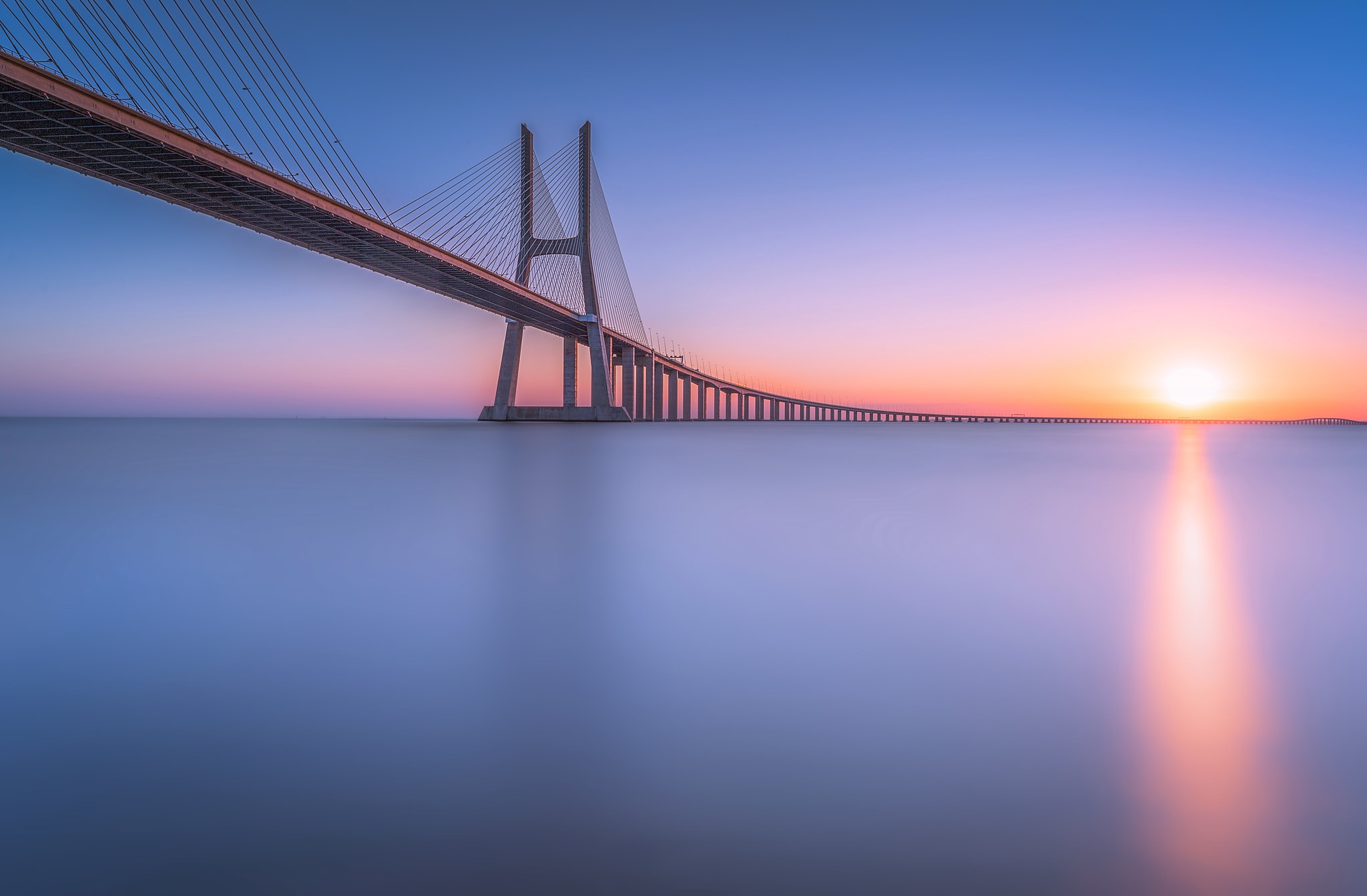 Vasco da Gama Bridge over Tagus River at Sunset HD Wallpaper