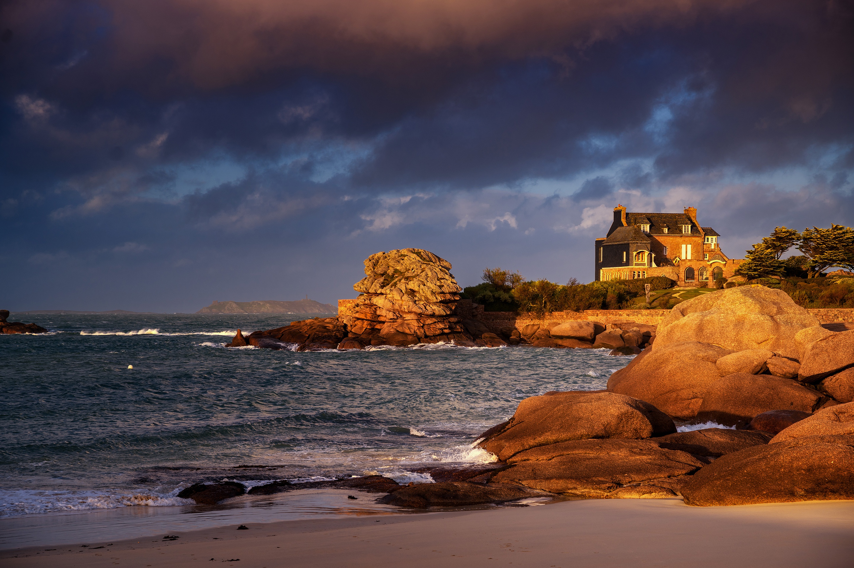 House on a rocky coast with stormy sea HD Wallpaper
