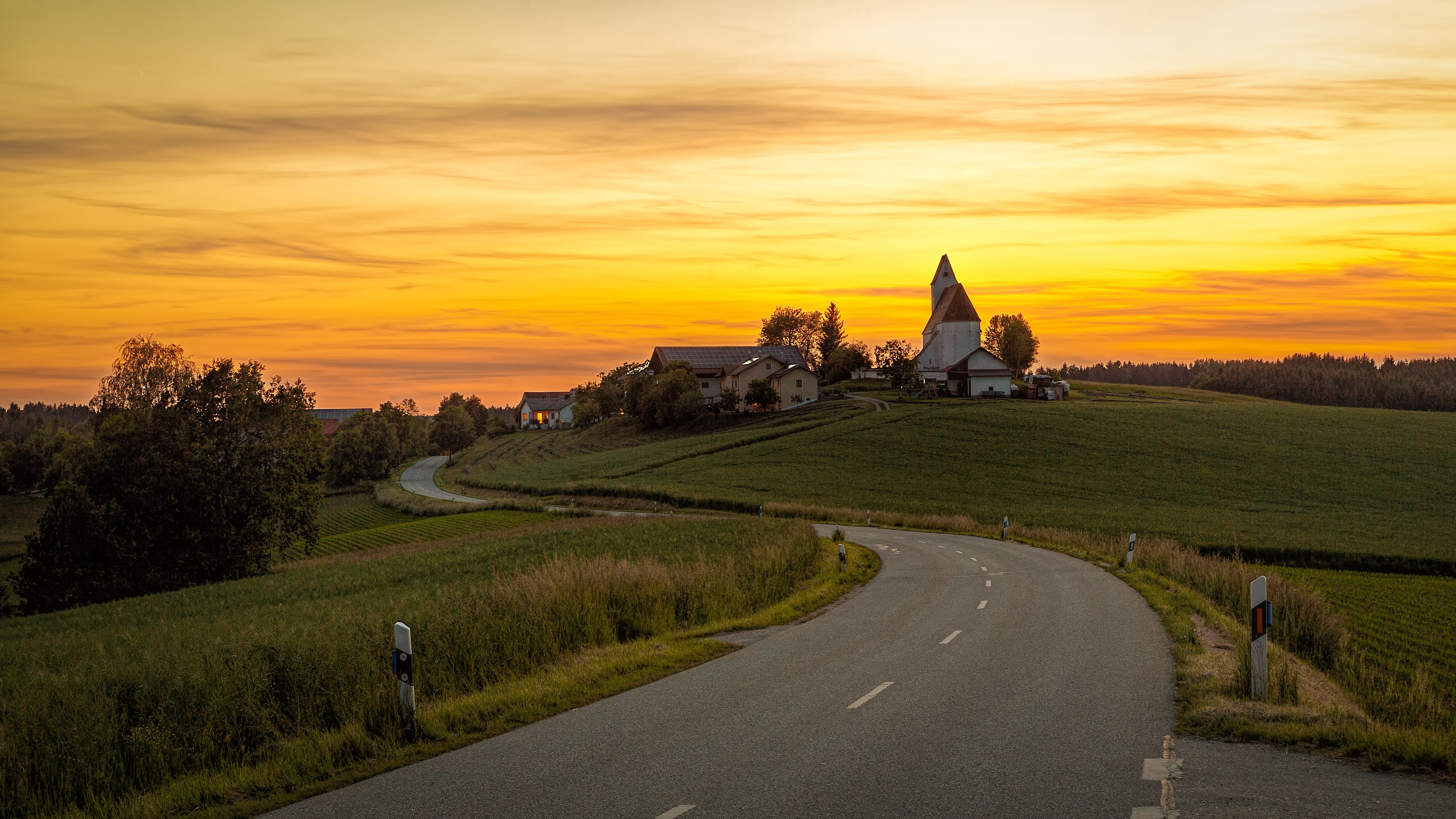 Road through rolling hills at sunset in Germany HD Wallpaper