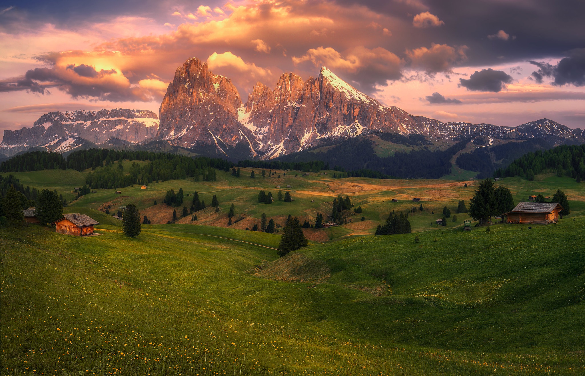 Alps mountain range with huts and meadows at sunset HD Wallpaper