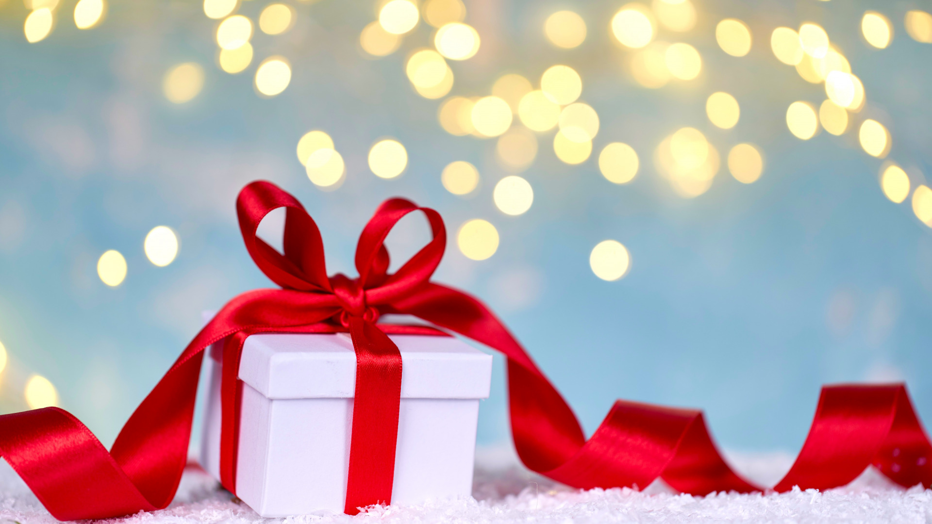 White gift box with red ribbon and bokeh lights HD Wallpaper