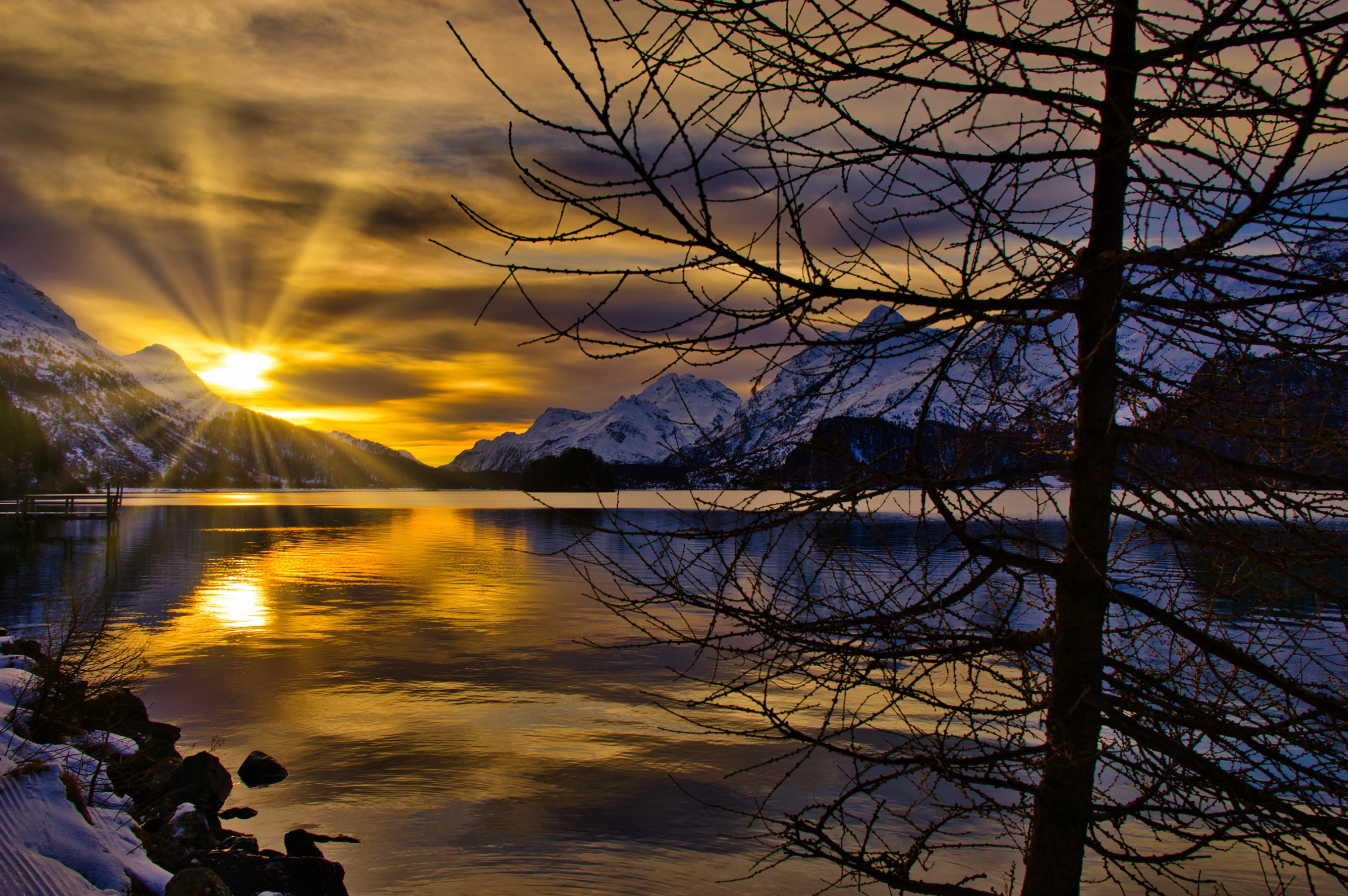 Sunset over a snowy mountain lake in Switzerland HD Wallpaper