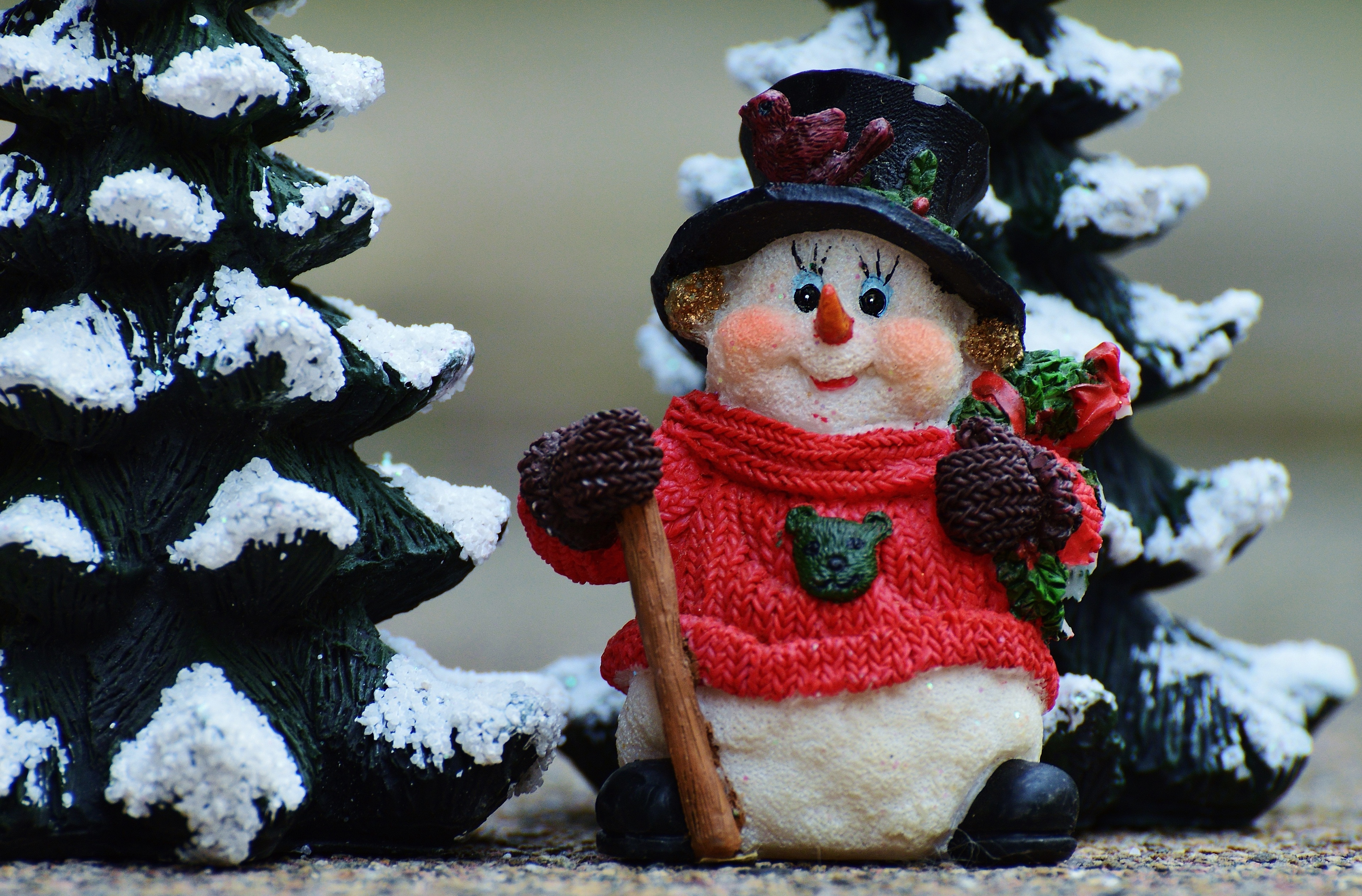 Christmas snowman figurine with snow-covered trees HD Wallpaper