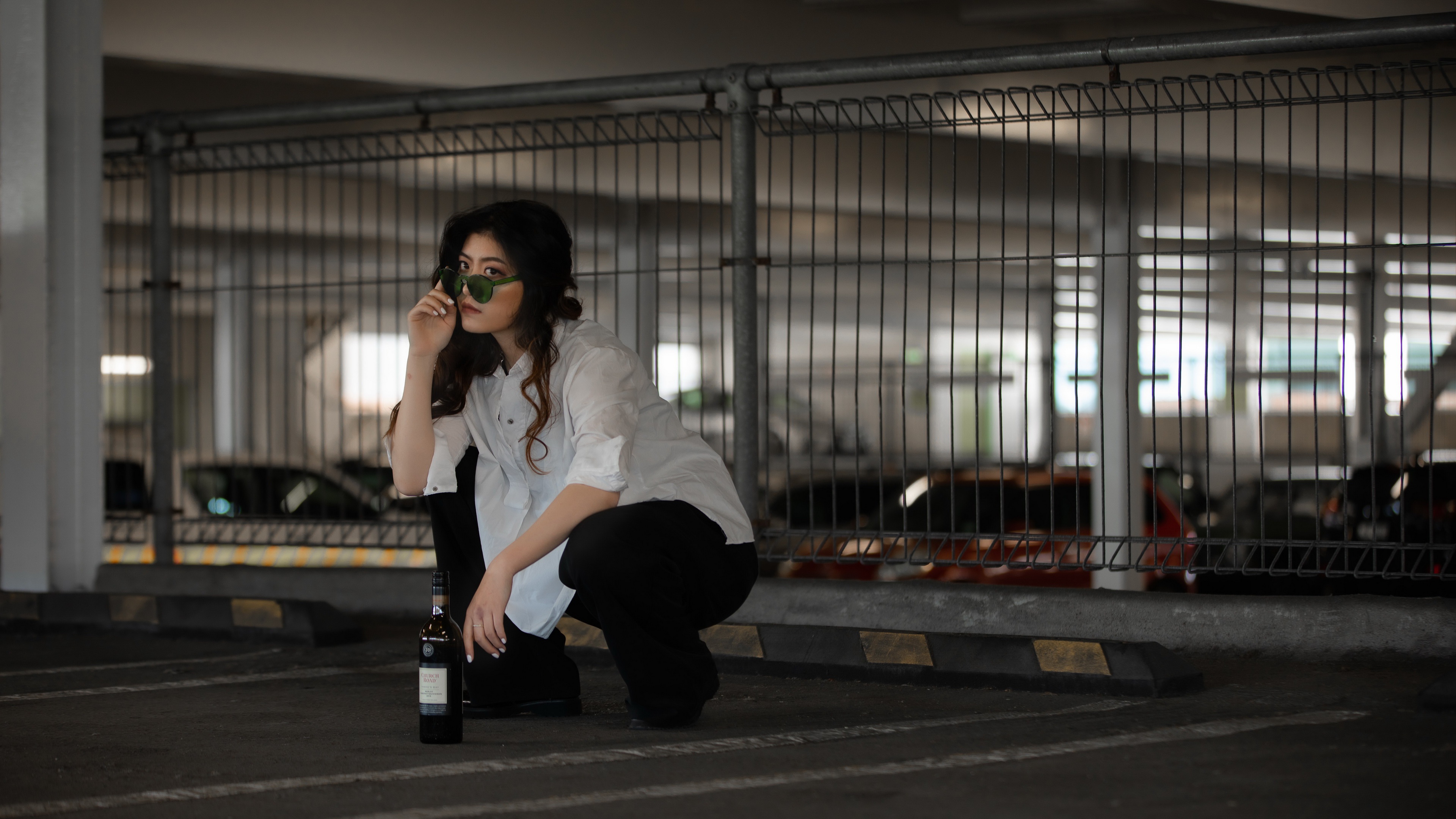 Woman with Sunglasses and Bottle in Parking Lot HD Wallpaper