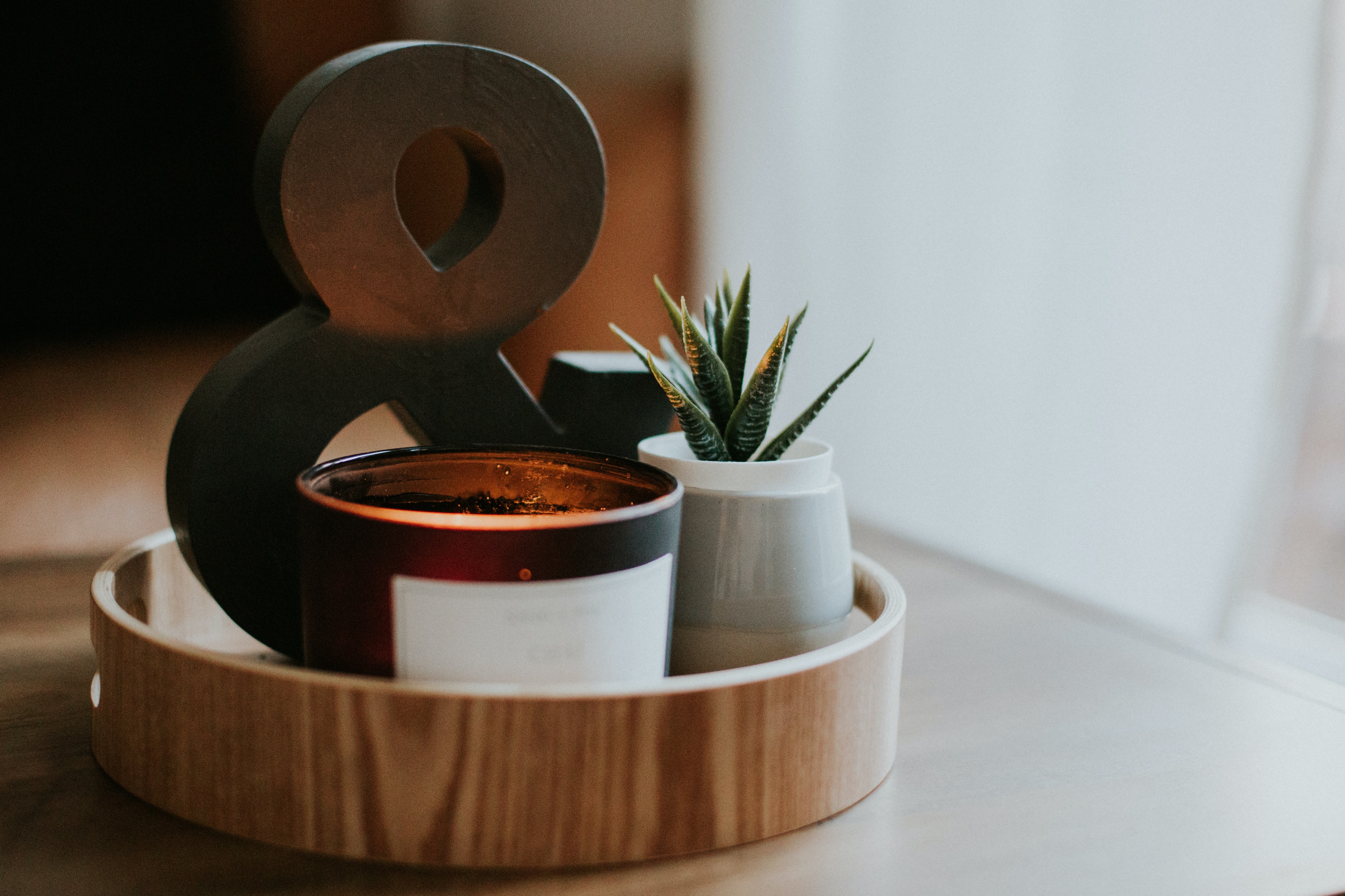 Decorative tray with ampersand, candle, and succulent HD Wallpaper