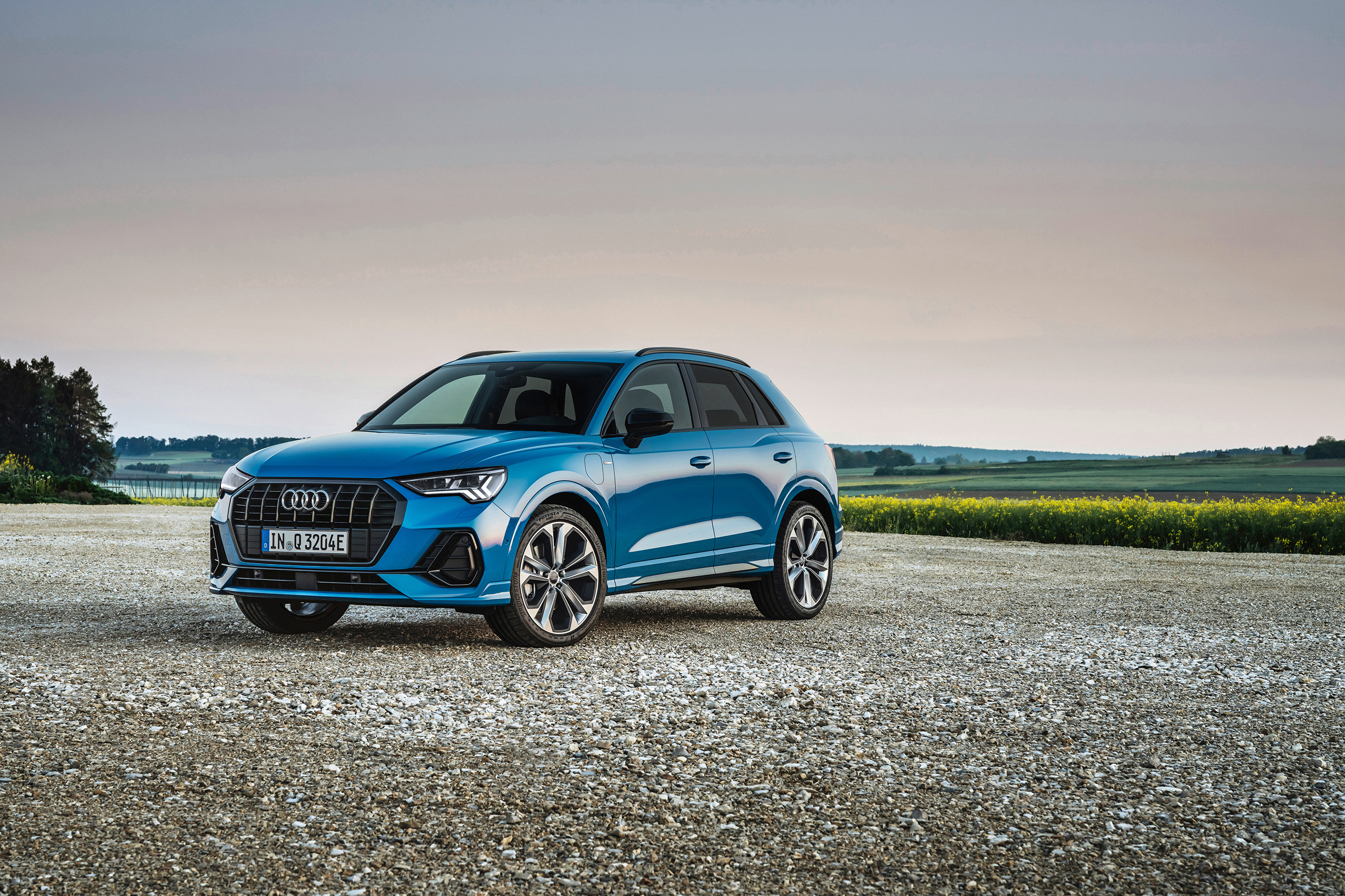 Blue Audi Q3 4K SUV parked on gravel road HD Wallpaper
