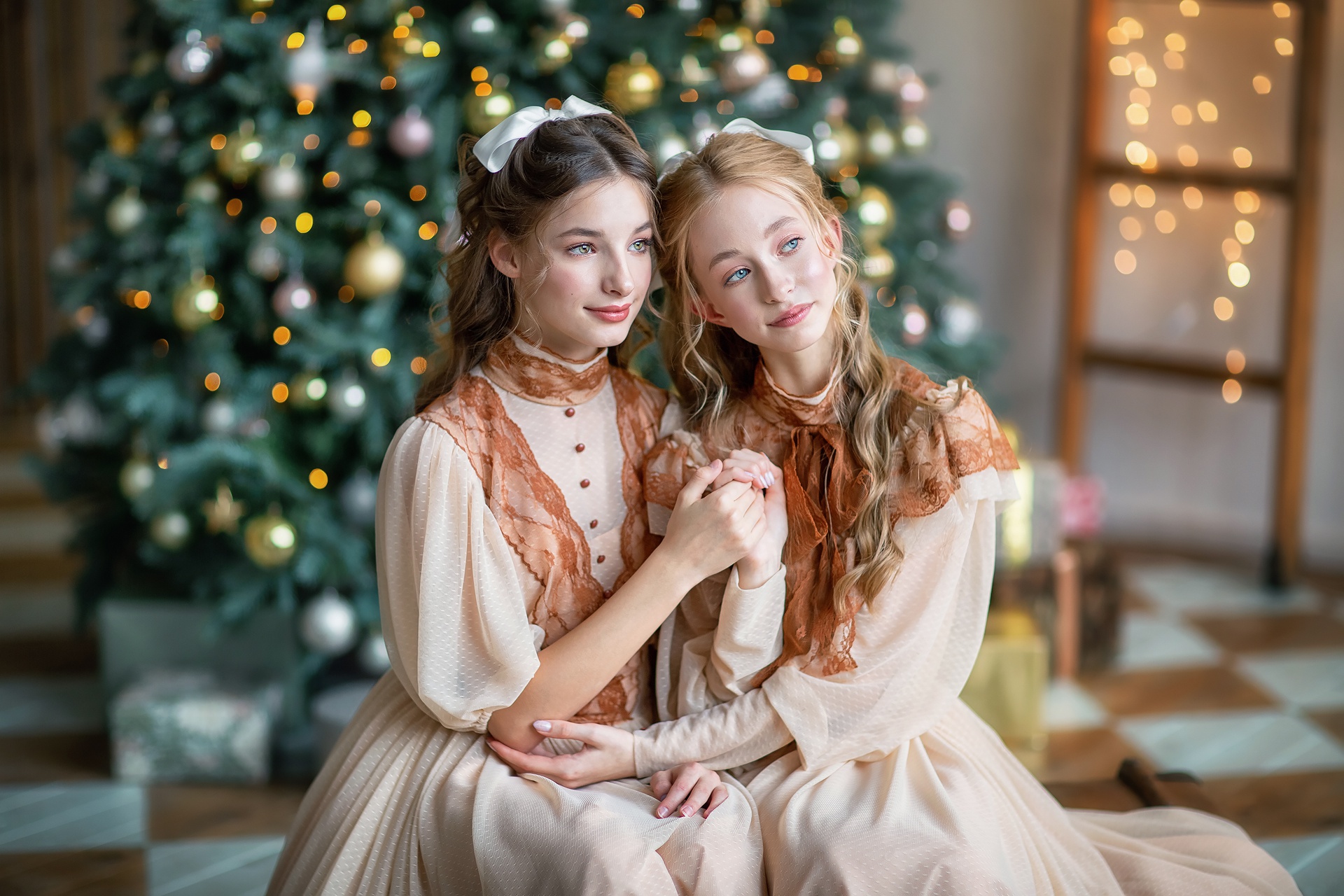 Two girls in vintage dresses by a Christmas tree HD Wallpaper