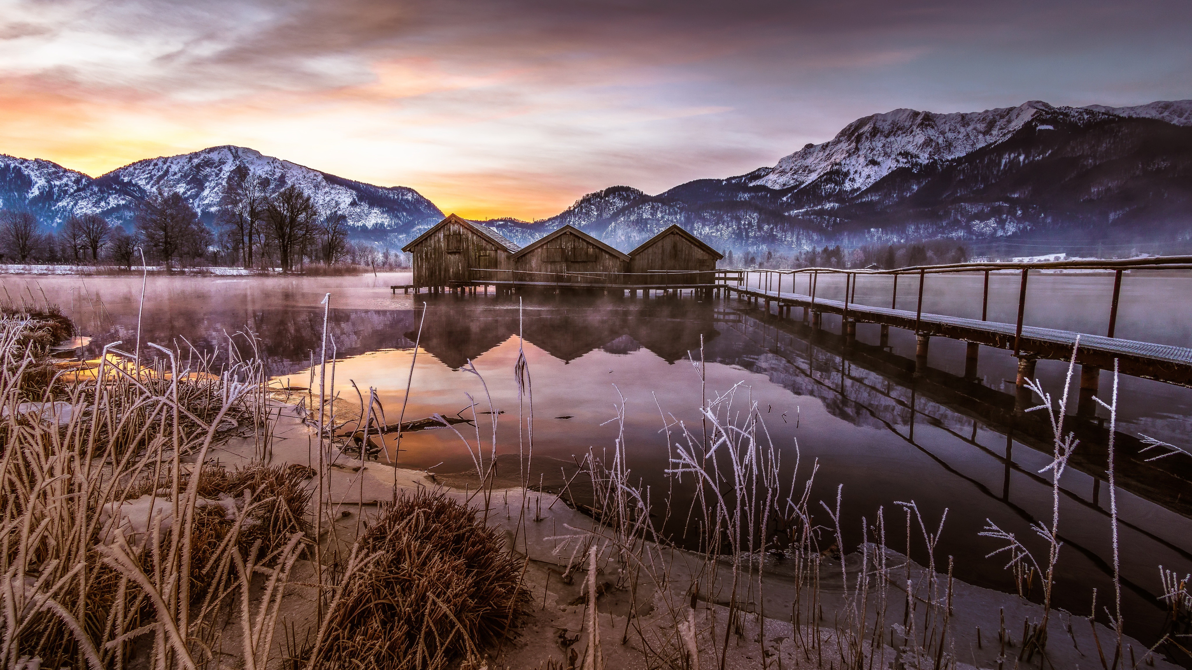 Wooden Boathouses on a Lake with Mountains in Winter HD Wallpaper